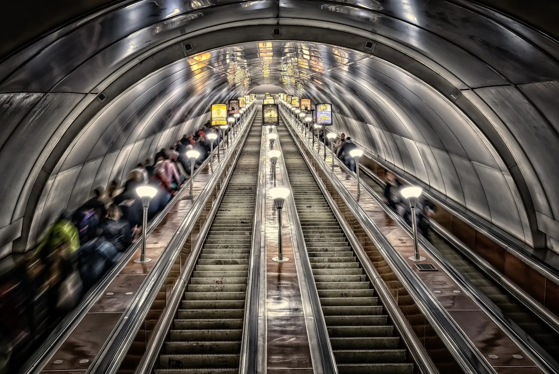 people walking on escalator inside building