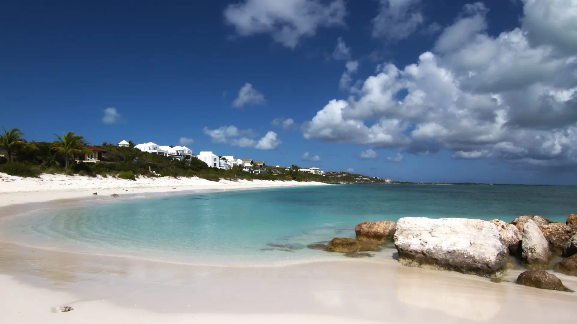 A beautiful tropical beach with white sand and turquoise water.
