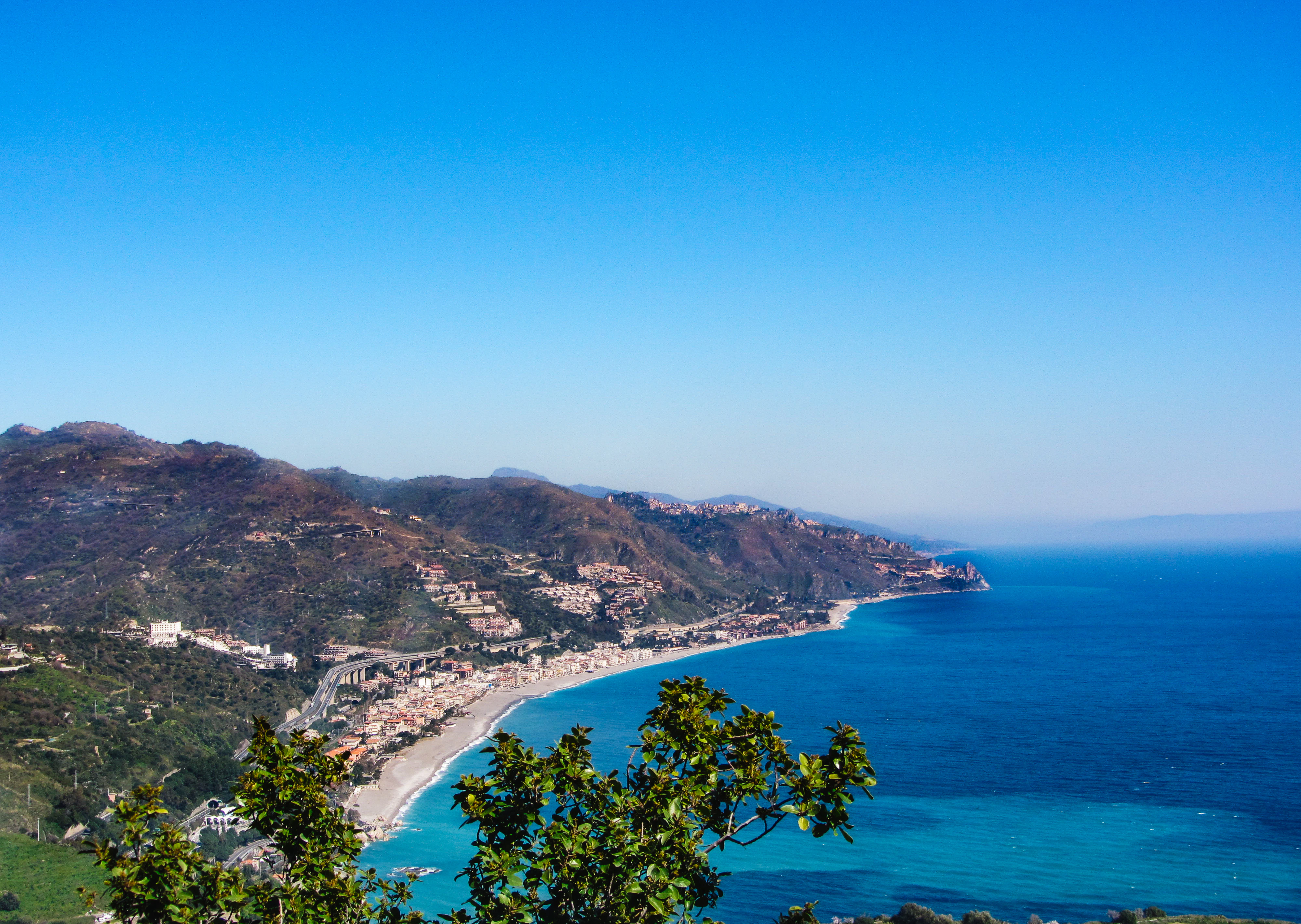 a scenic view of a beach and the ocean
