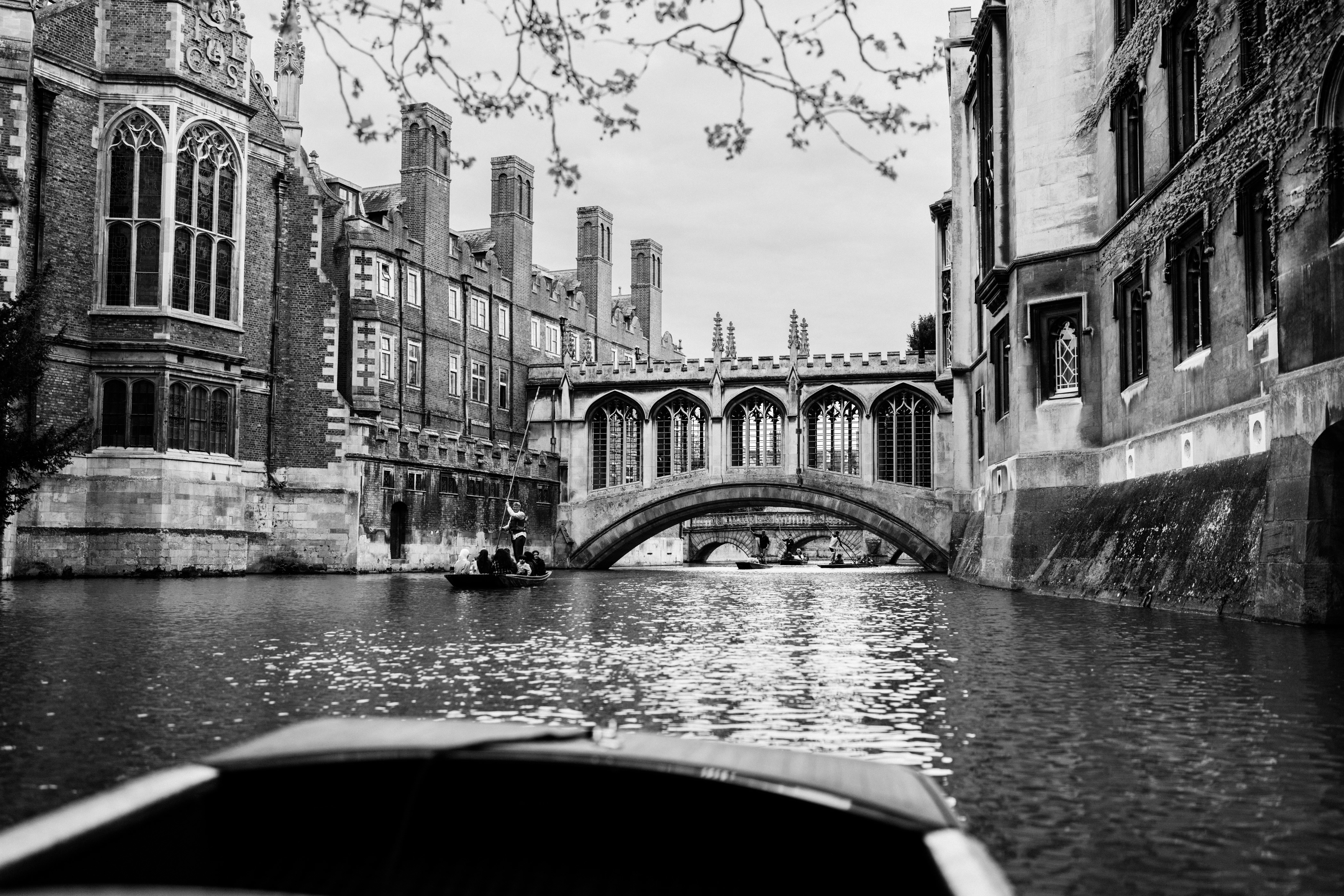 a boat traveling down a river next to tall buildings