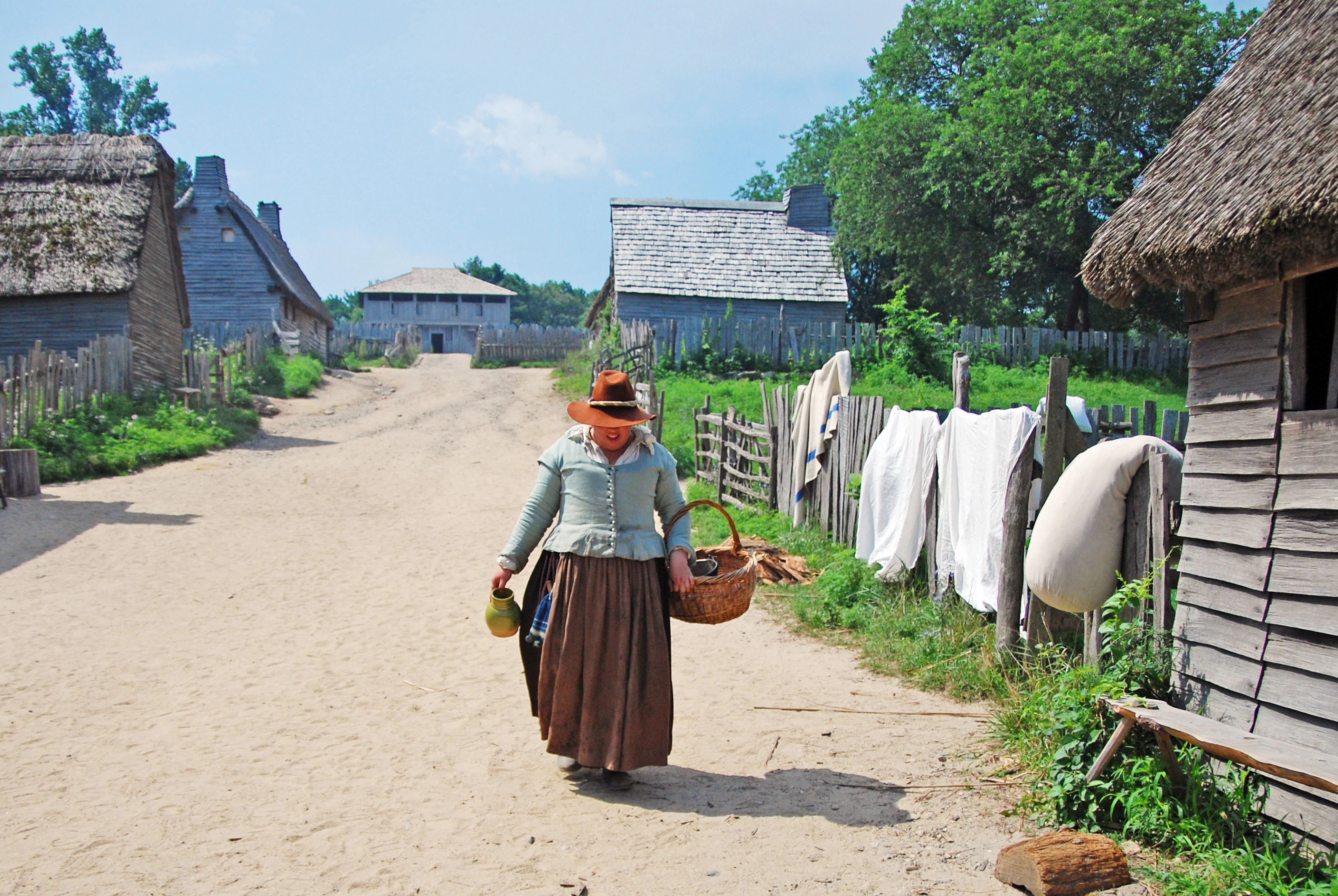 woman in brown and white dress holding brown woven basket