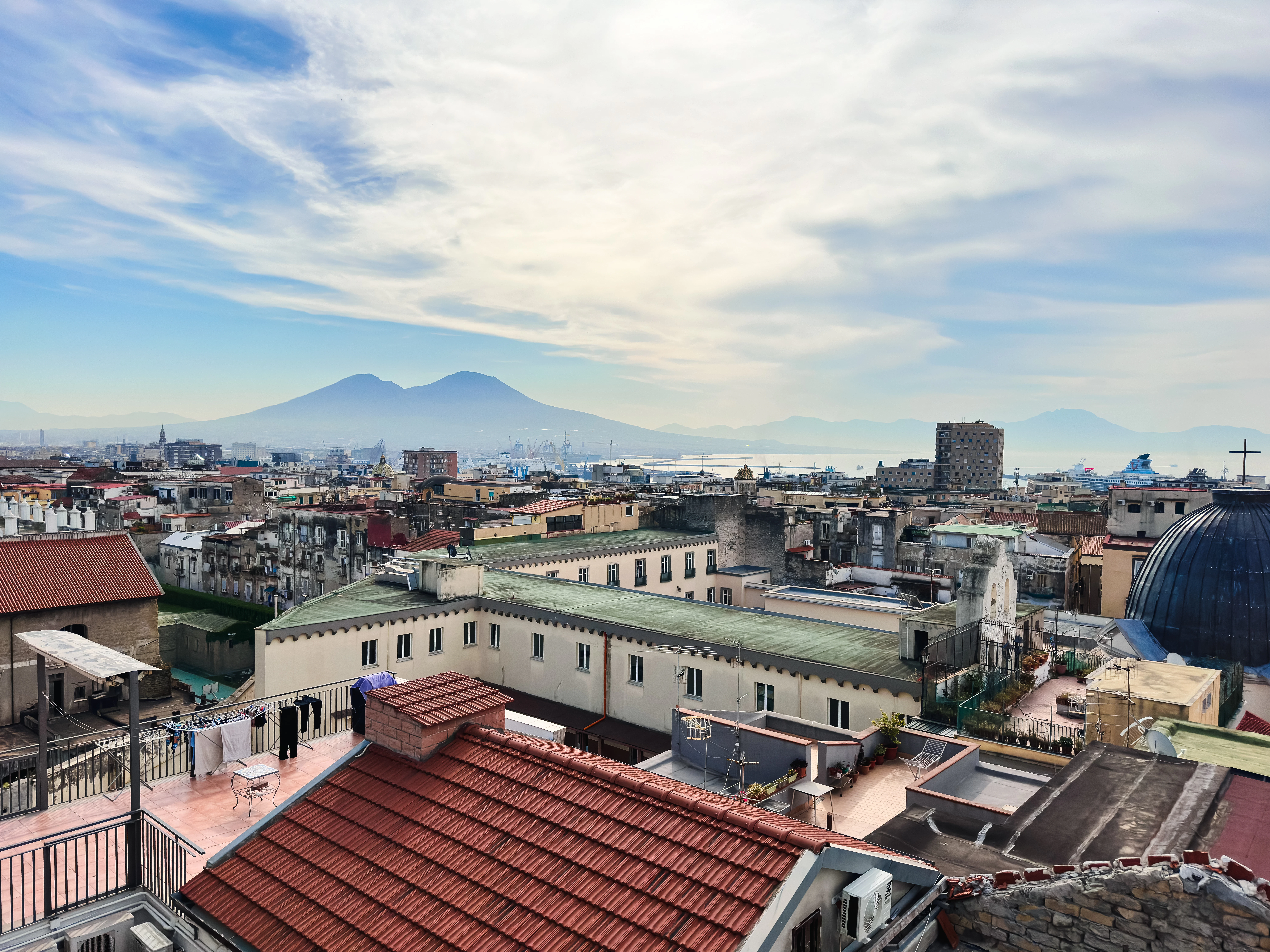 A panoramic view of a city with mountains in the background