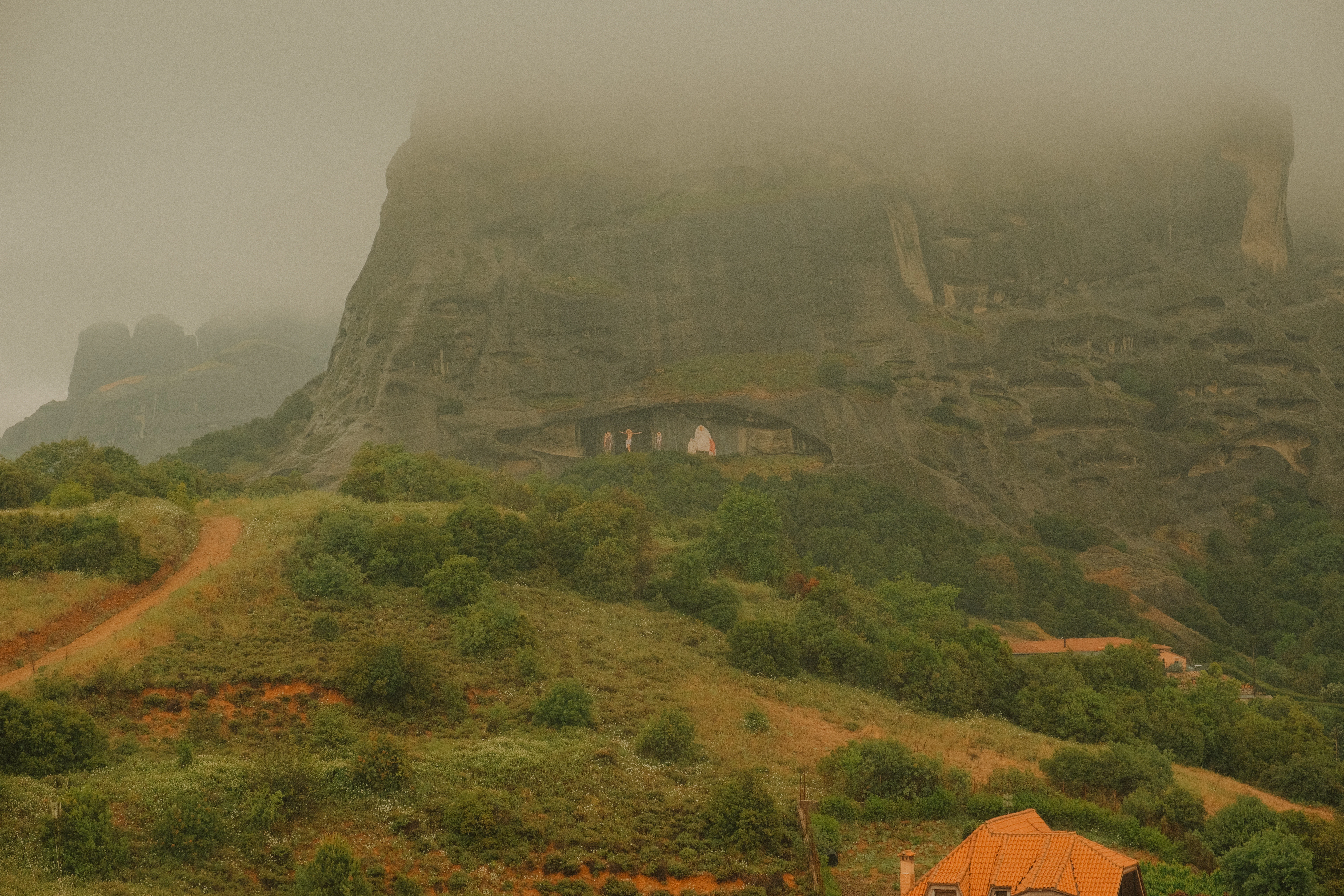 a house on a hill with a mountain in the background