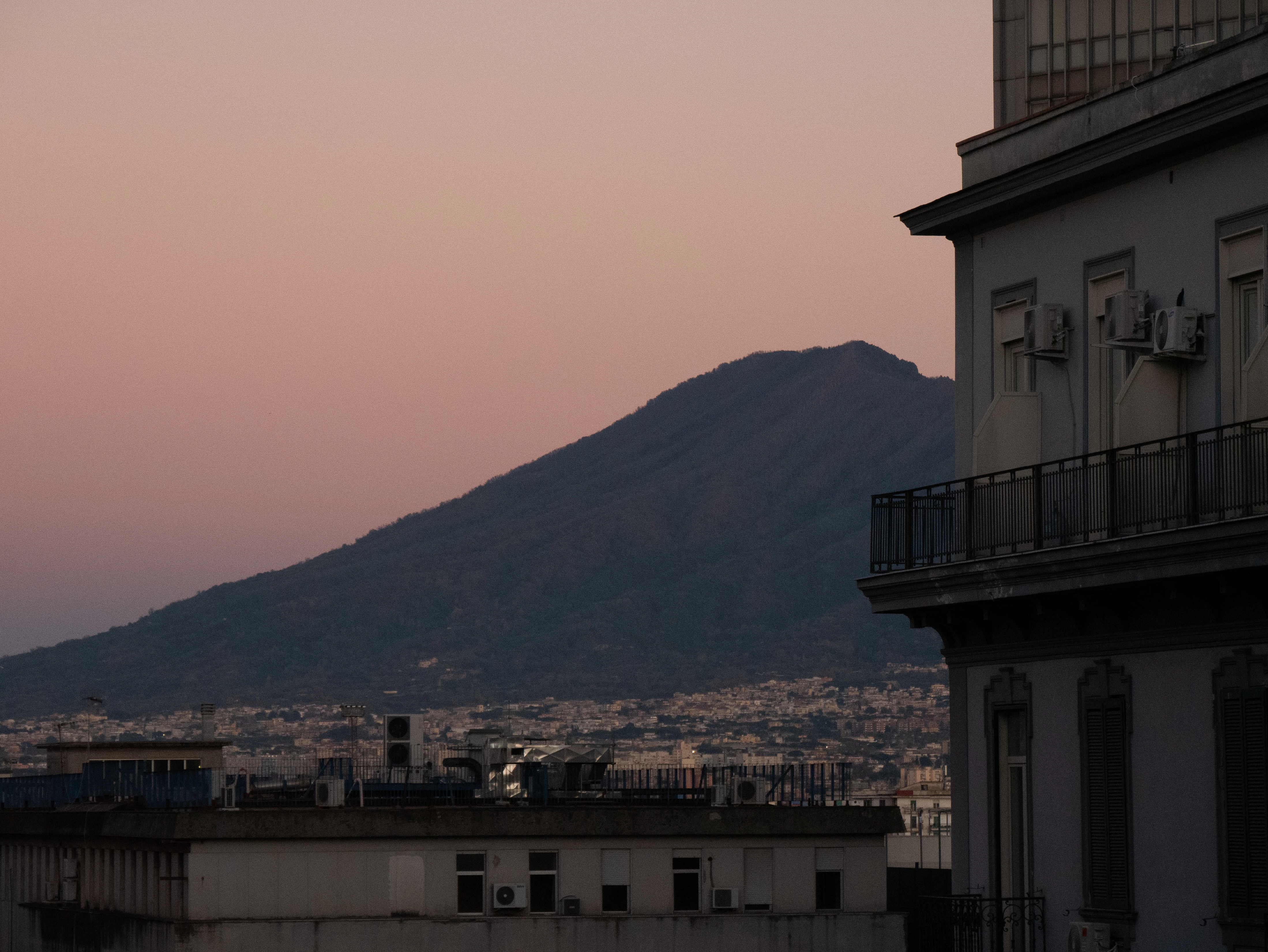 A view of a city with a mountain in the background