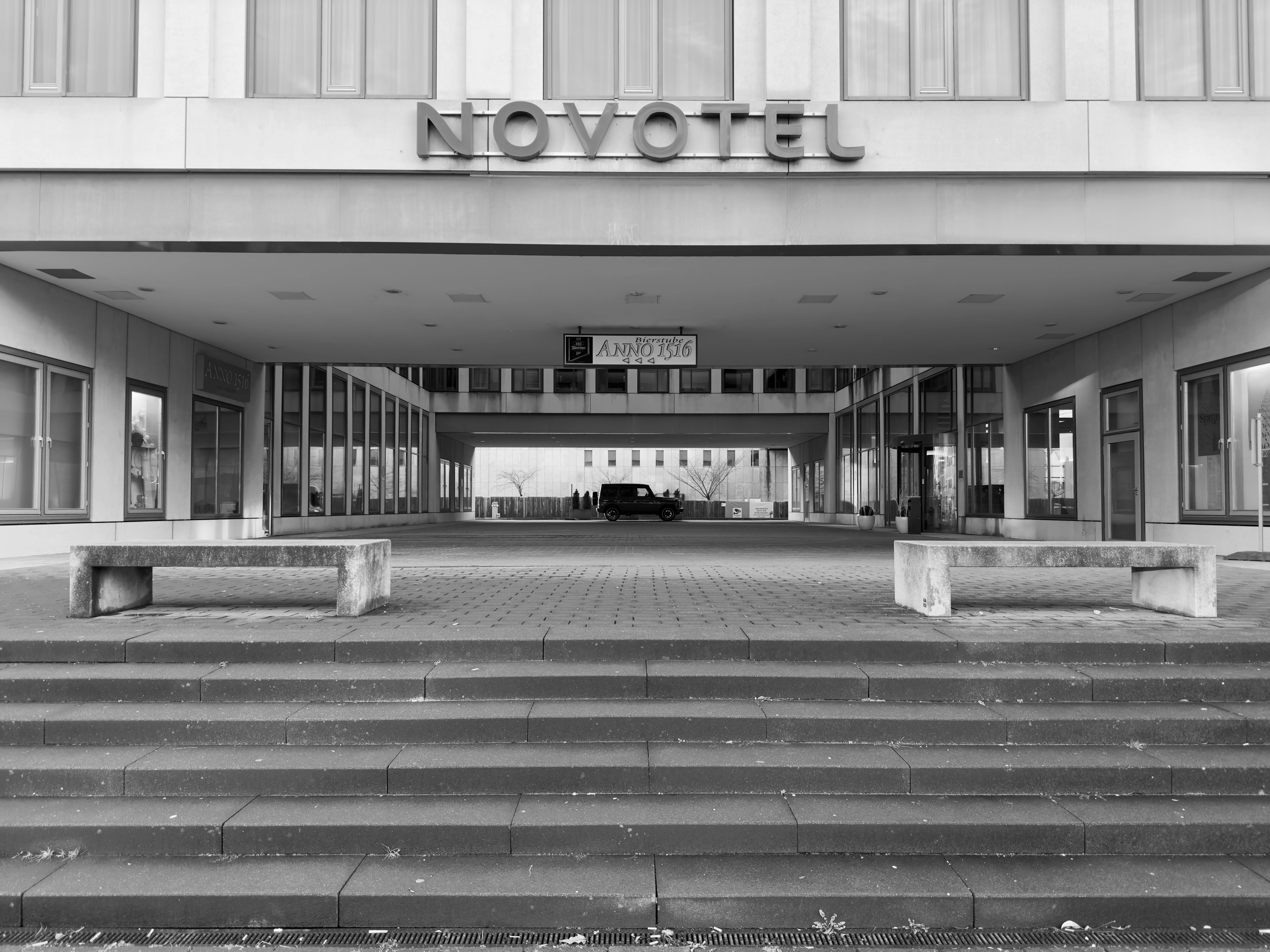 A black and white photo of a hotel entrance