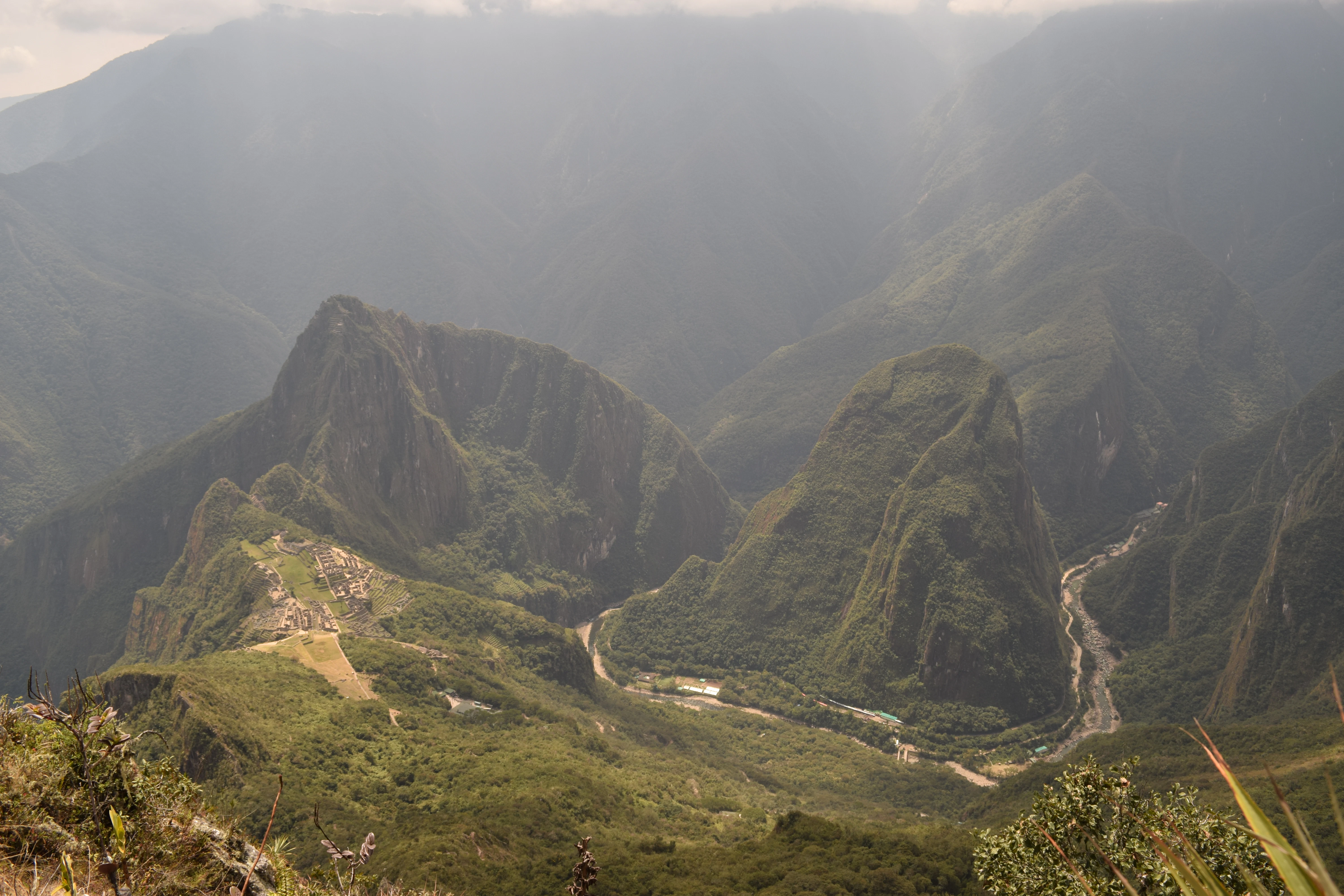 a valley with mountains in the background
