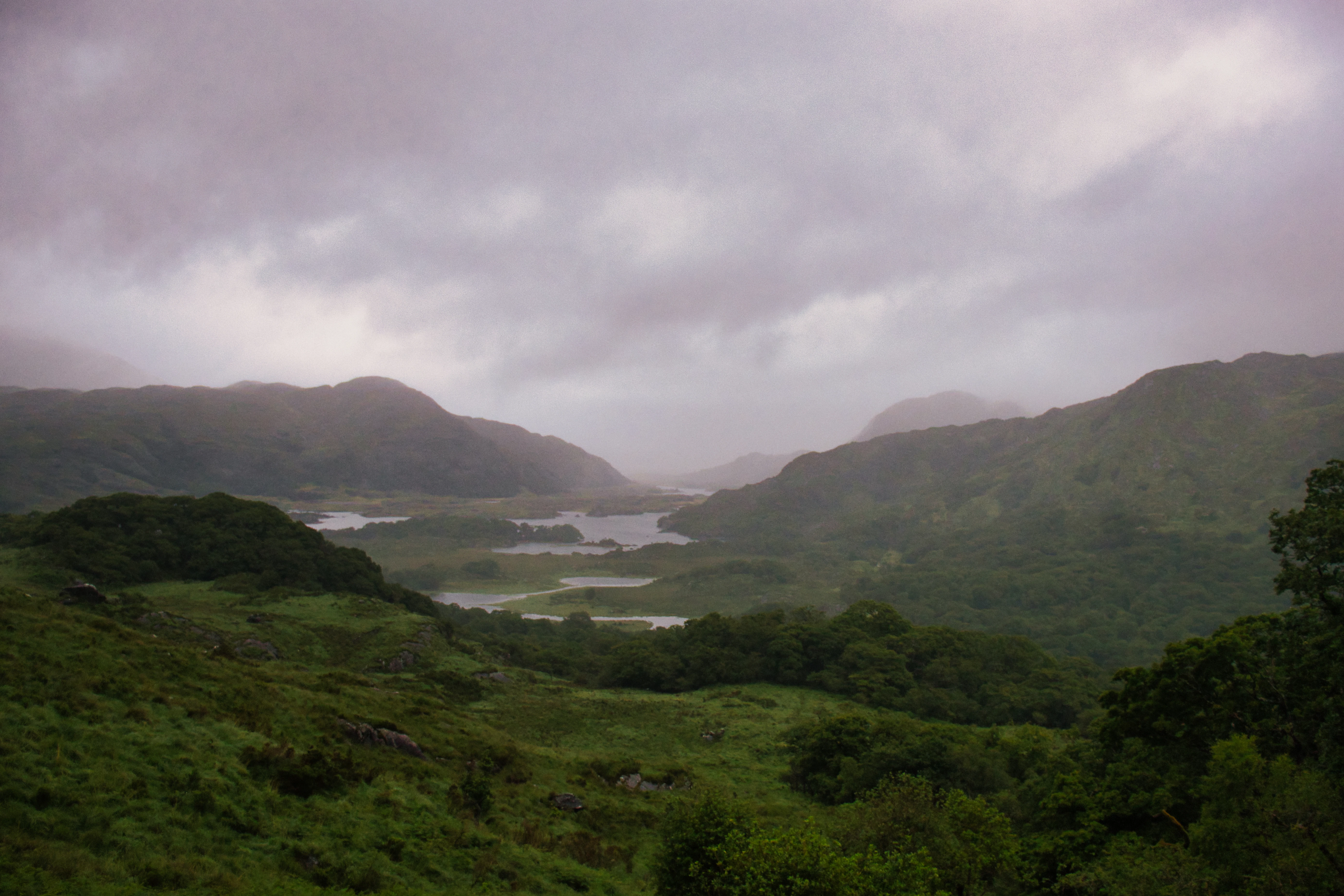 Misty mountains and lakes under a cloudy sky