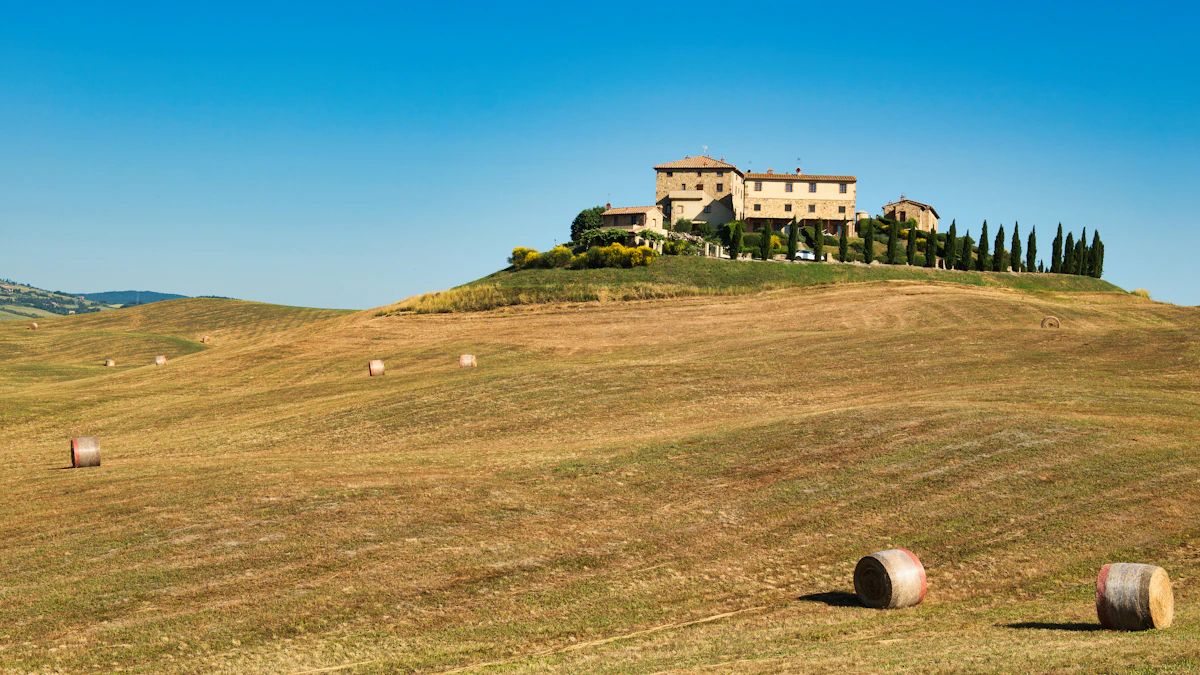 A building sits atop a hill in a scenic landscape.
