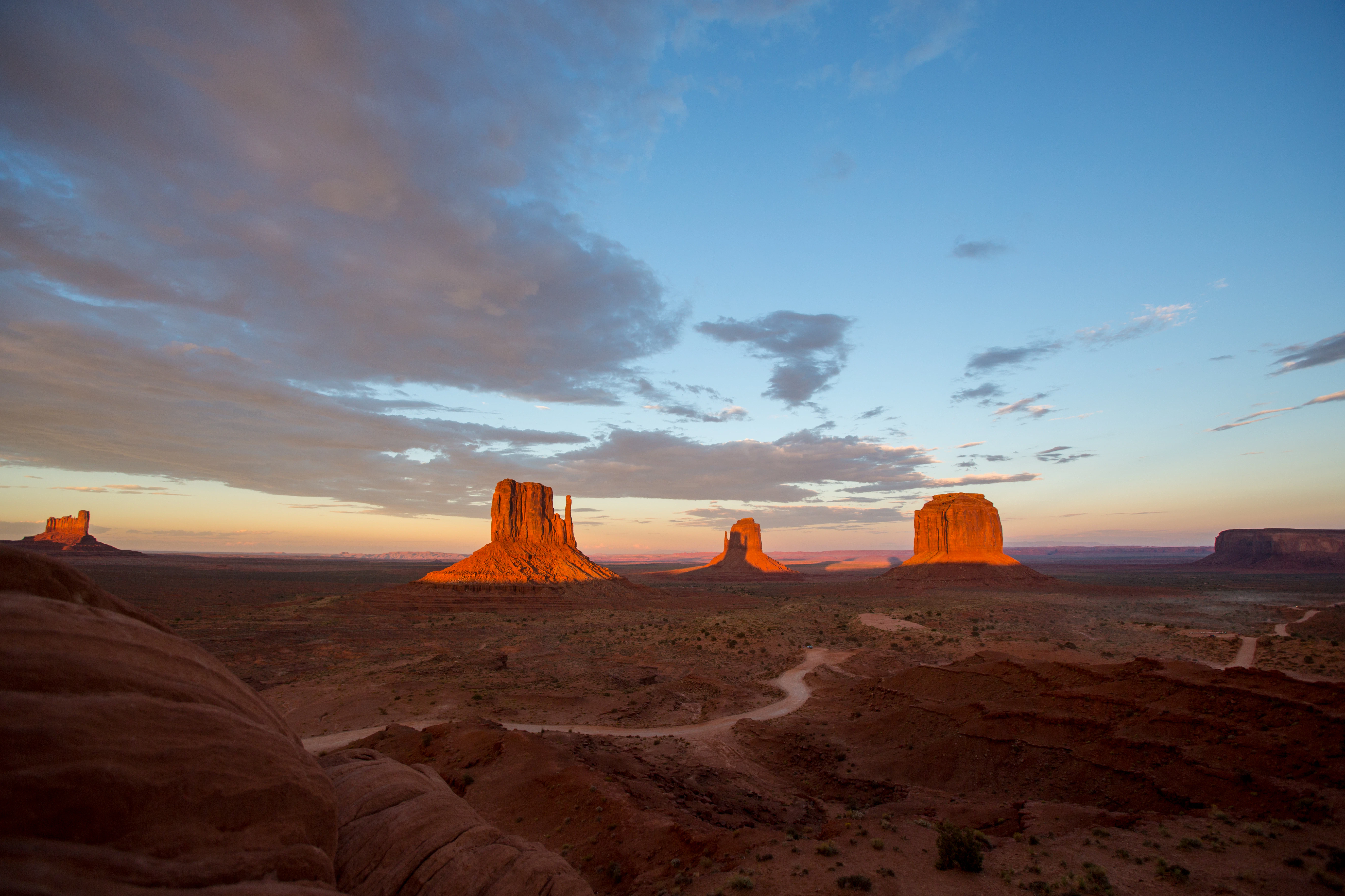 A desert landscape with a few rocks in the distance
