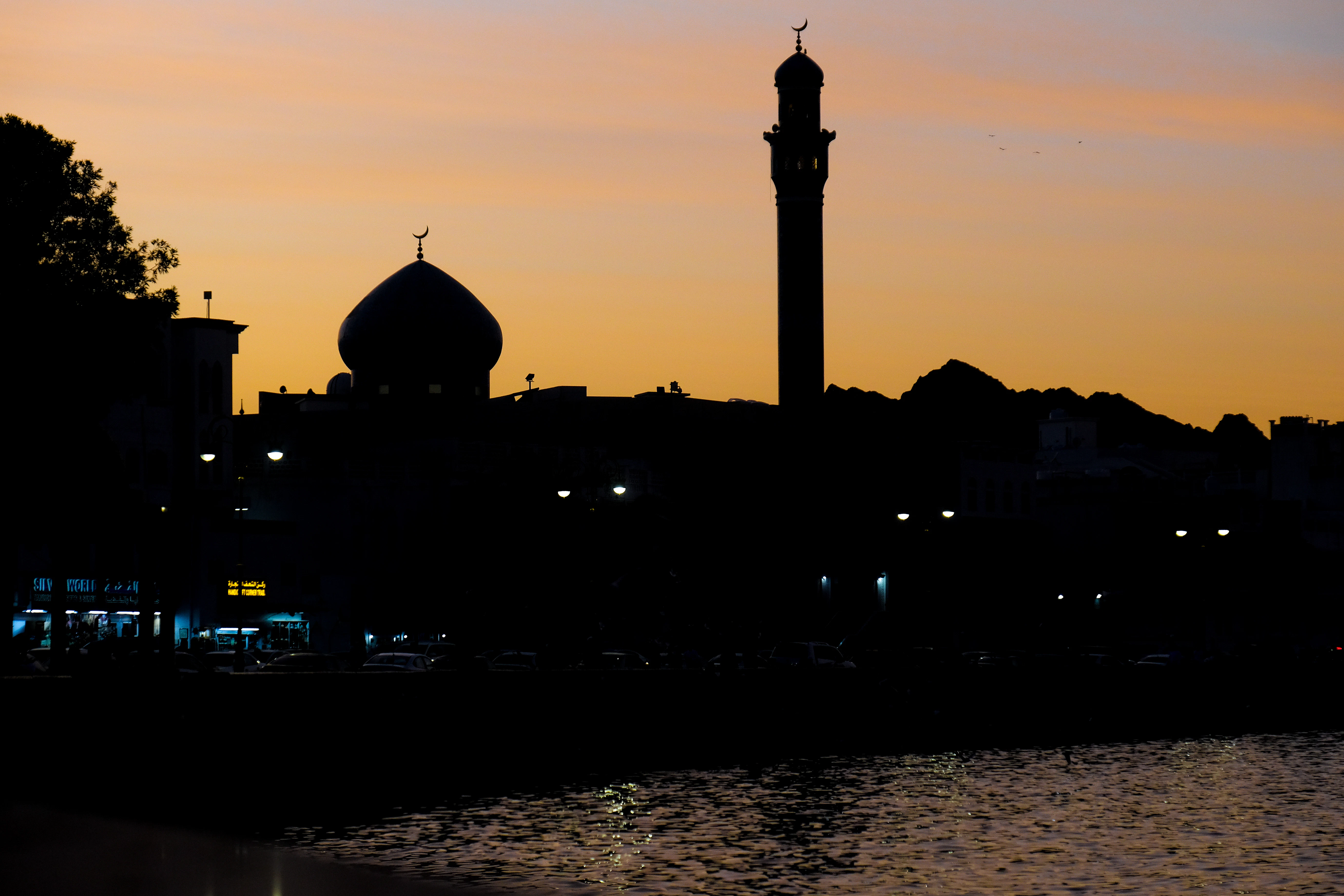 a large building sitting next to a body of water