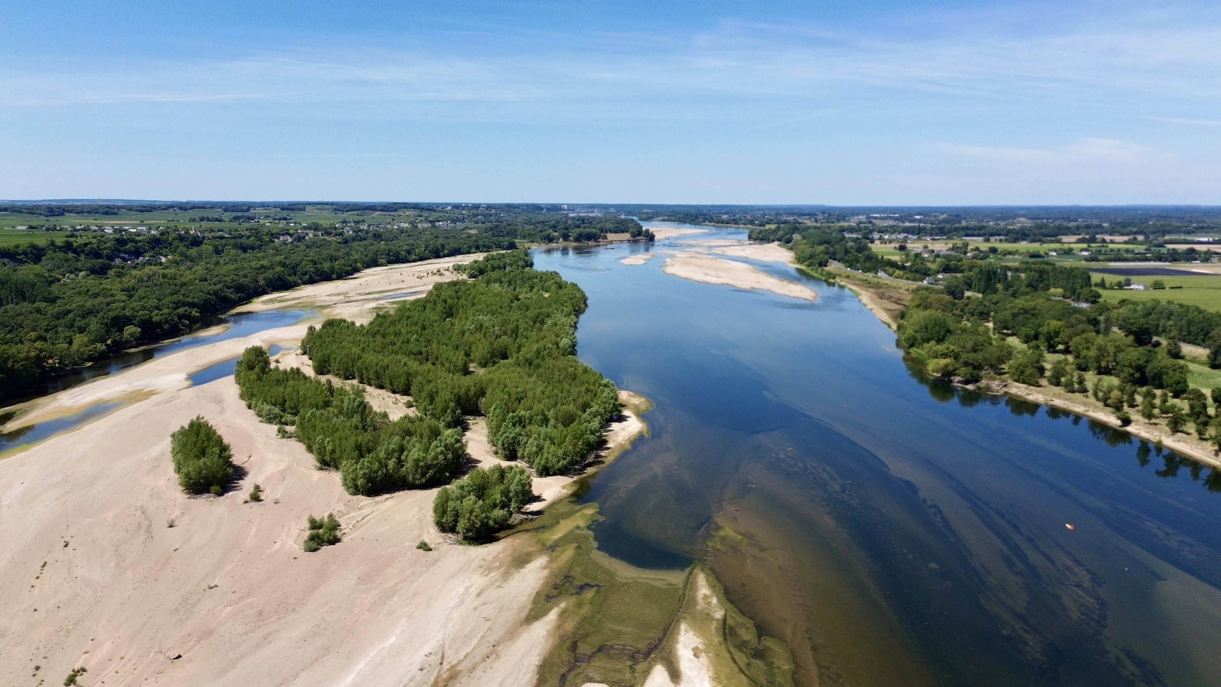 A river flows through a green landscape.