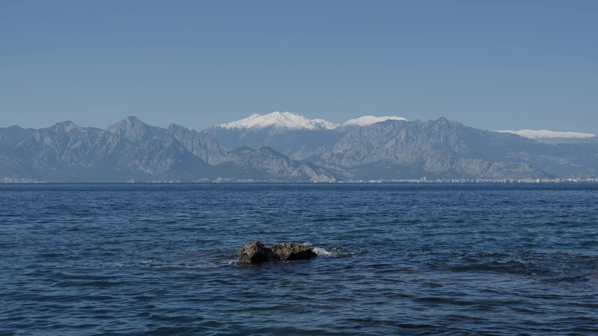 a large body of water with mountains in the background