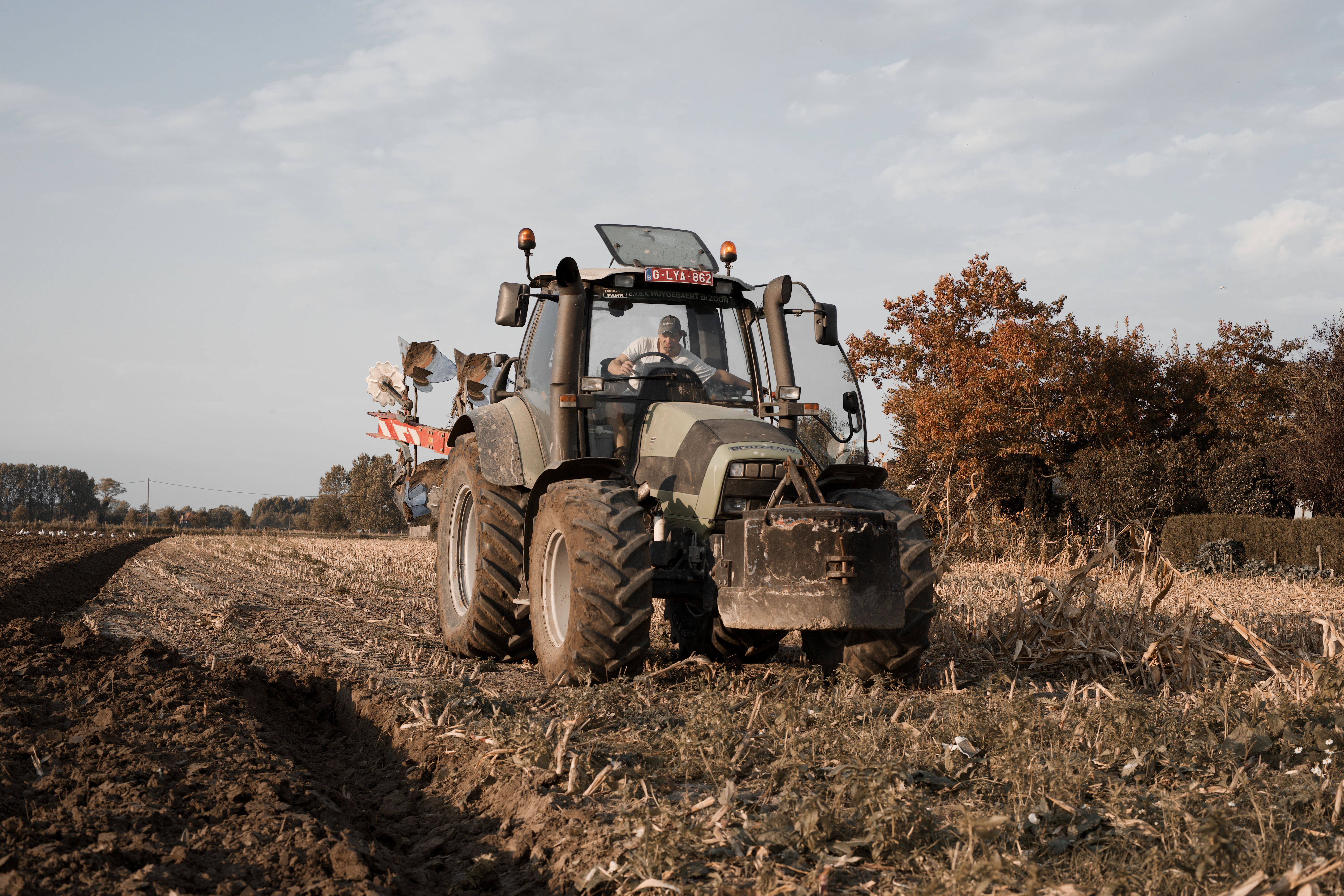 a tractor driving on a dirt road