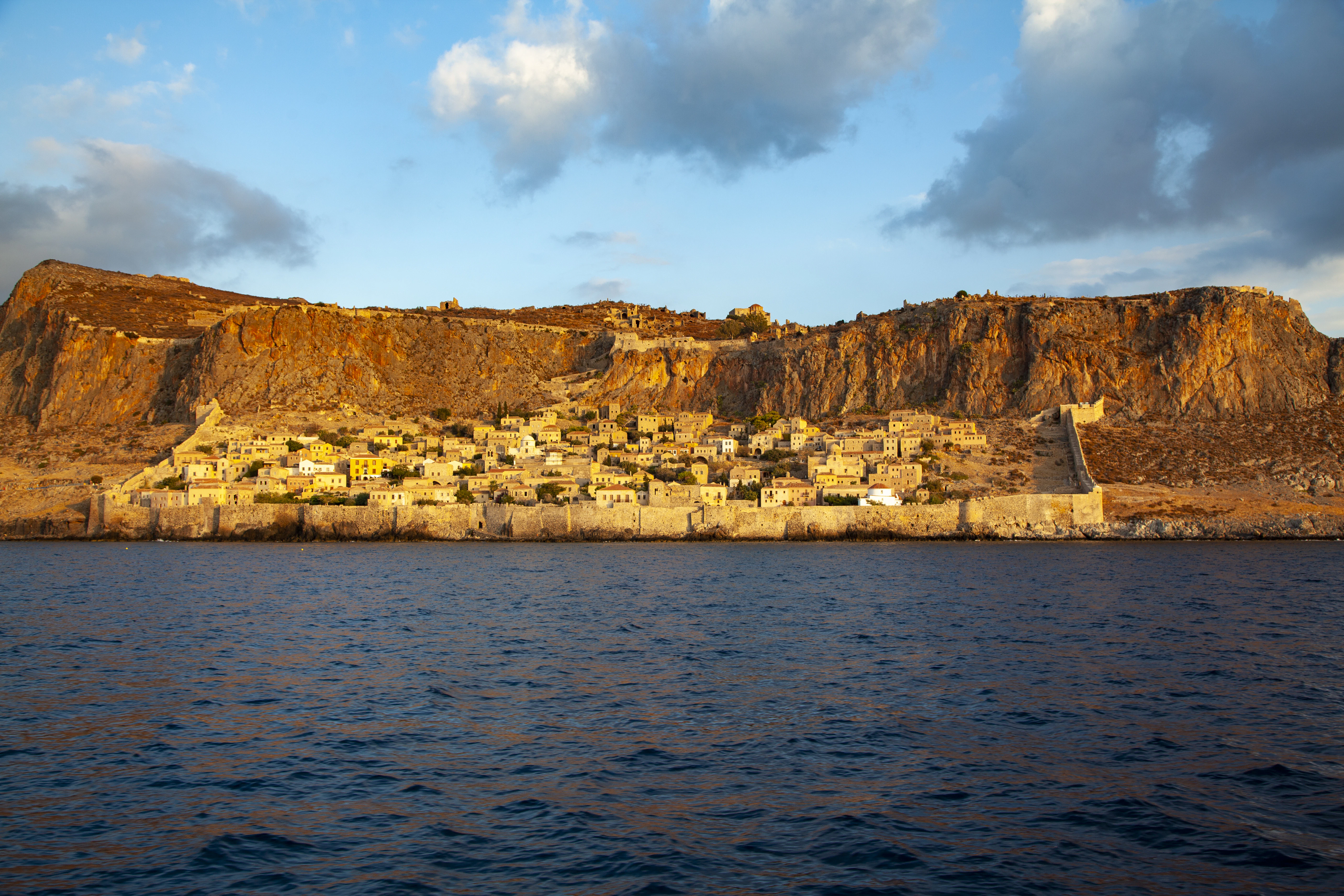 A large body of water with a mountain in the background