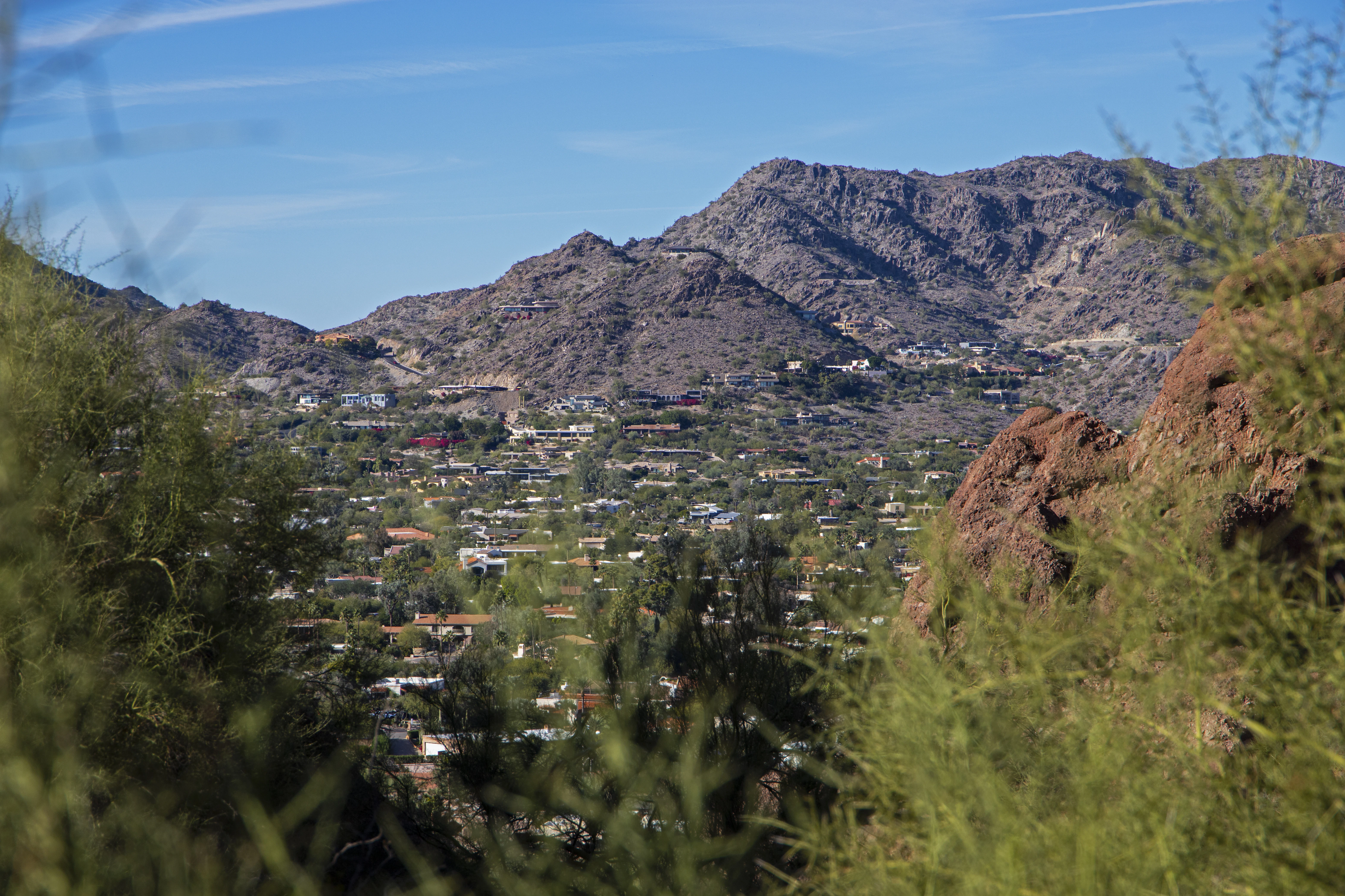 a view of a city in the distance with mountains in the background
