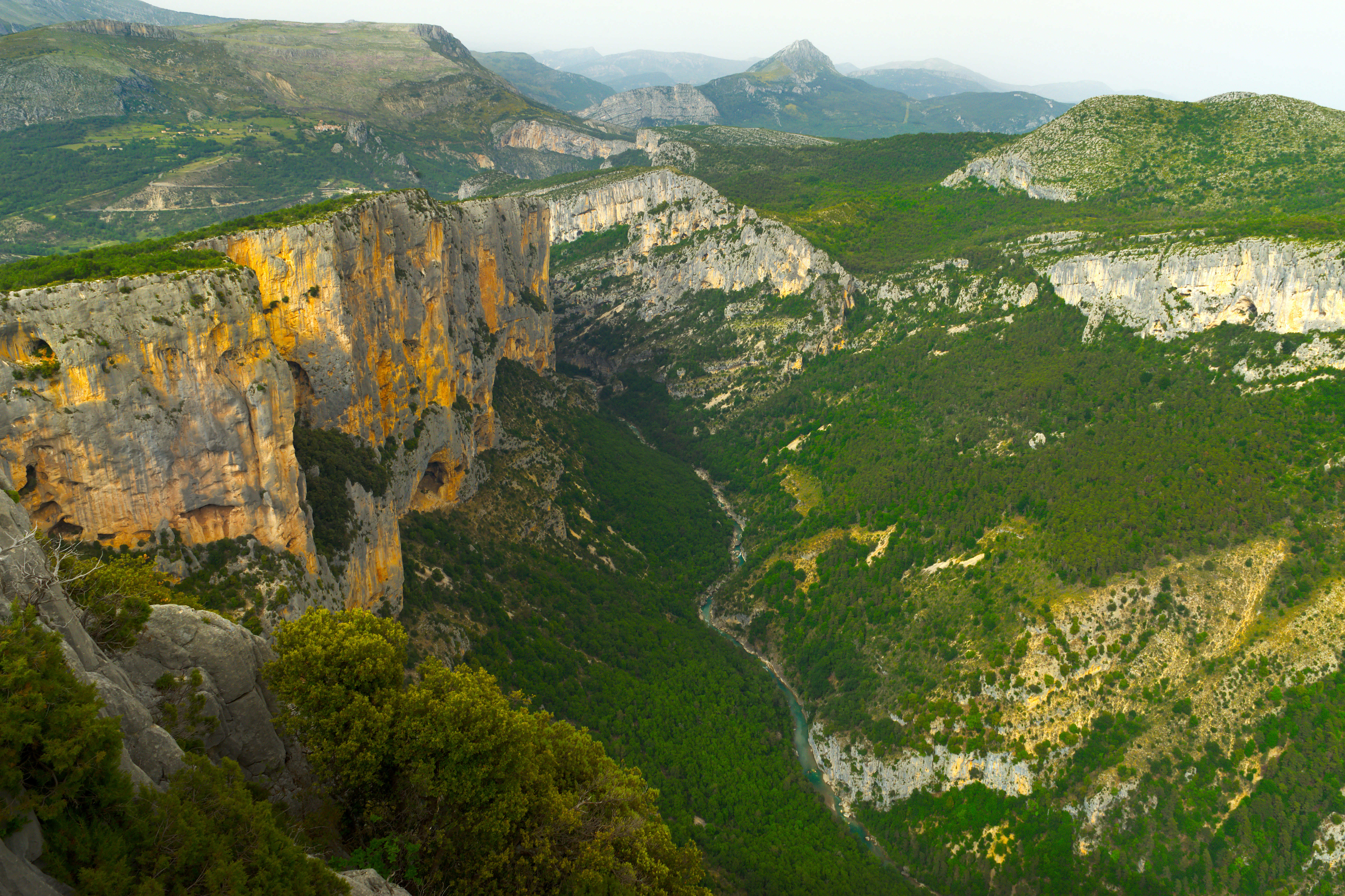 A scenic view of a valley with mountains in the background