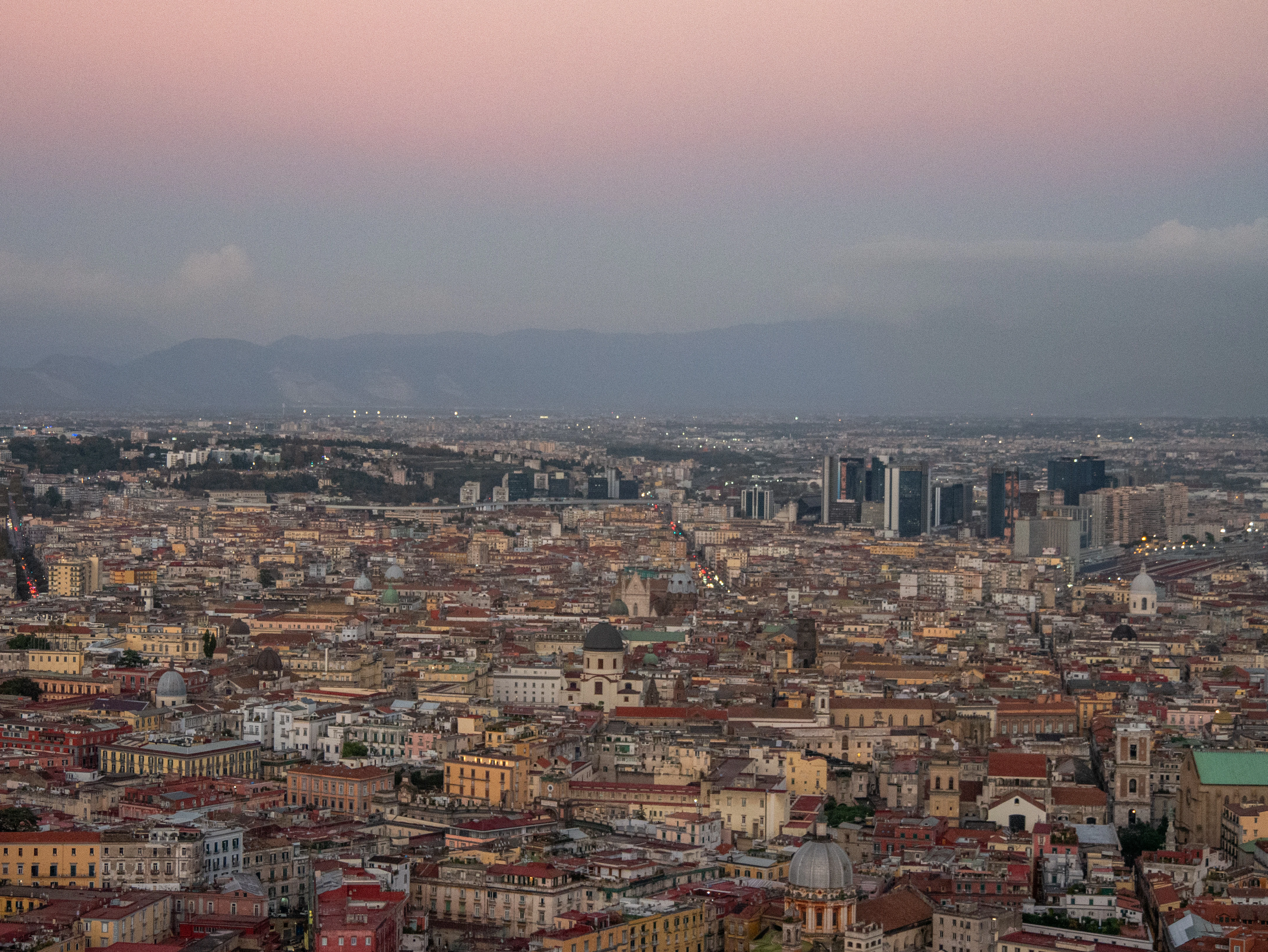 A view of a city from the top of a hill