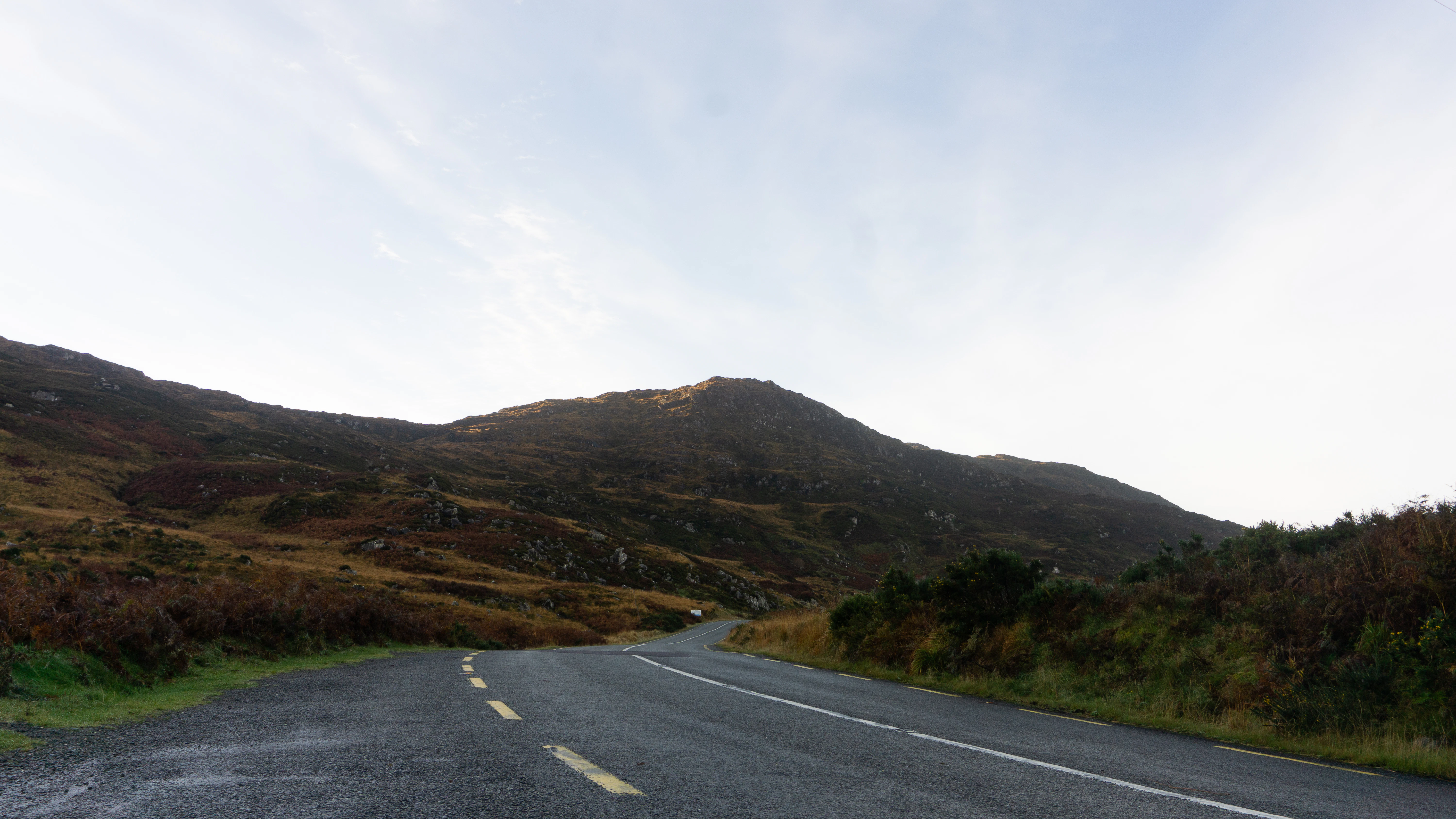 A road with a mountain in the background