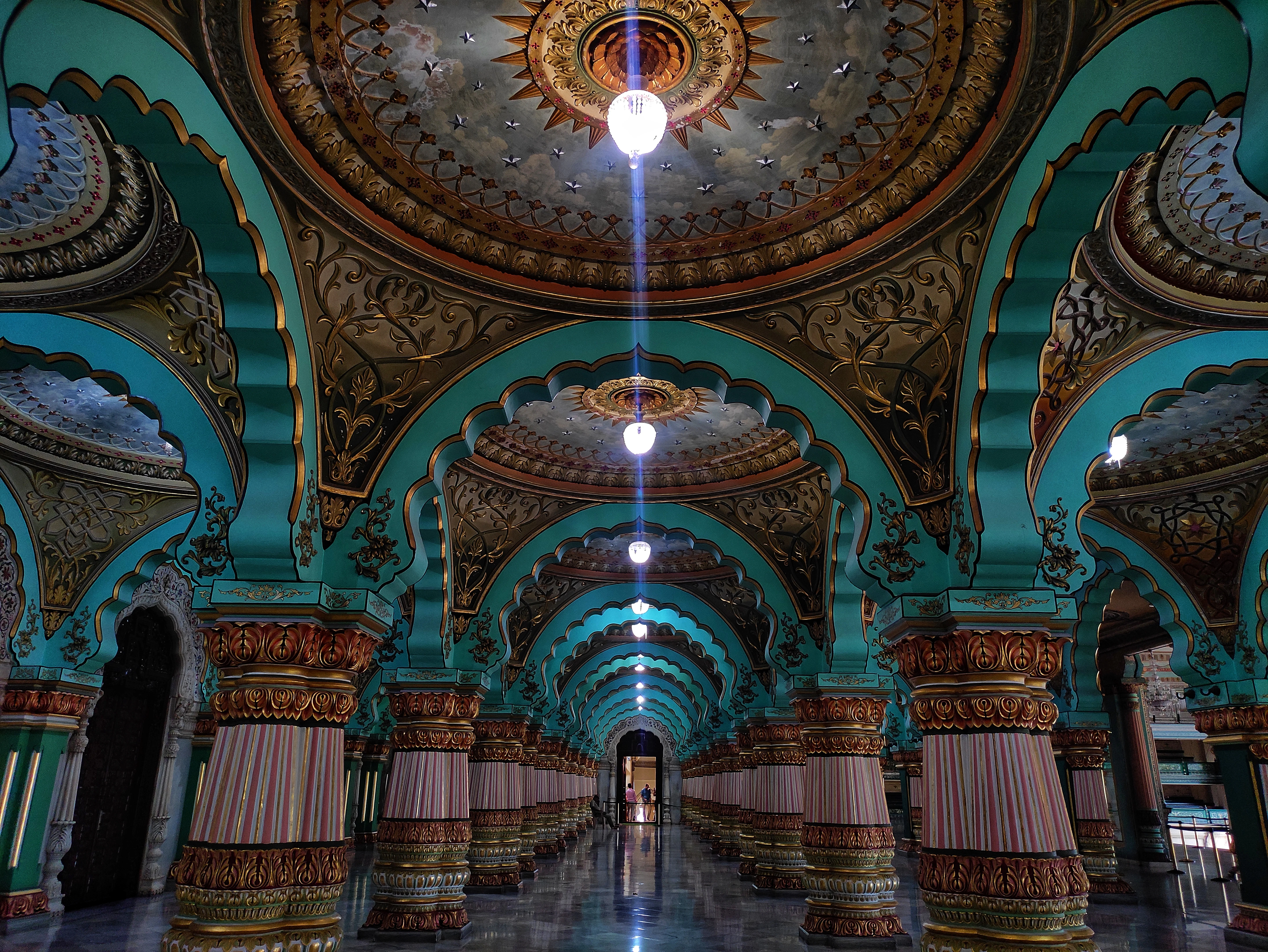 a large room with a ceiling and a chandelier