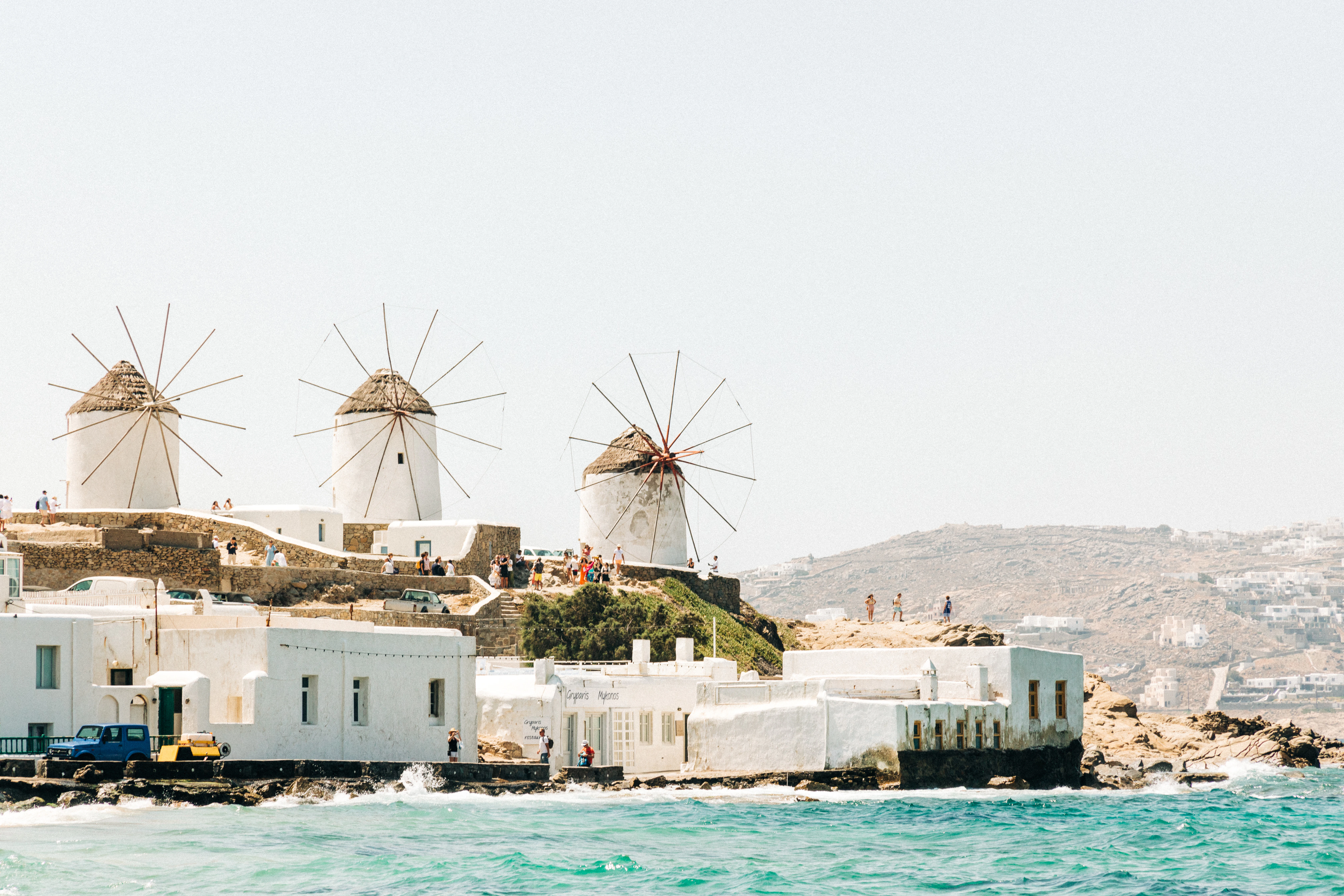 a group of white buildings next to a body of water