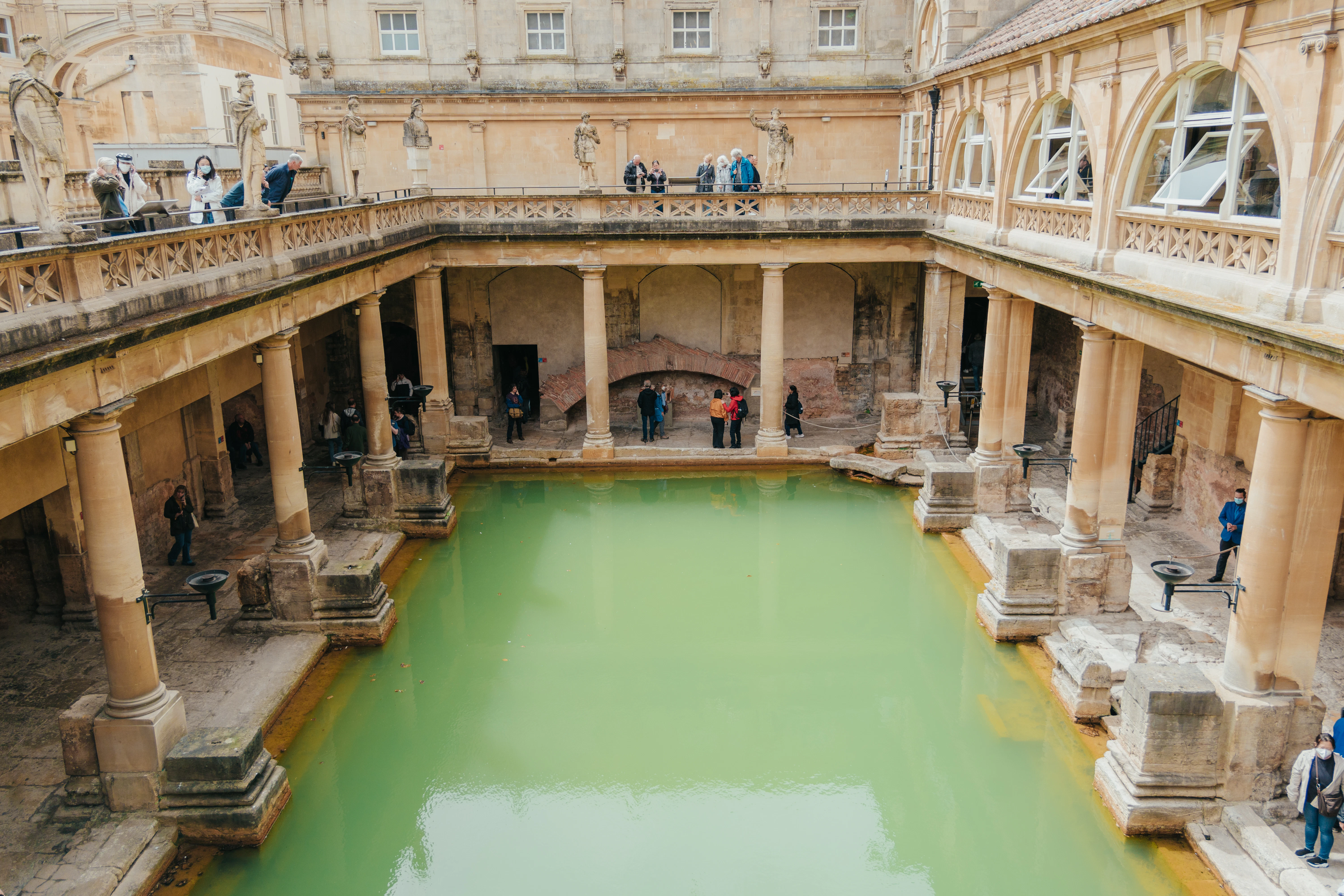 a group of people standing around a pool of water