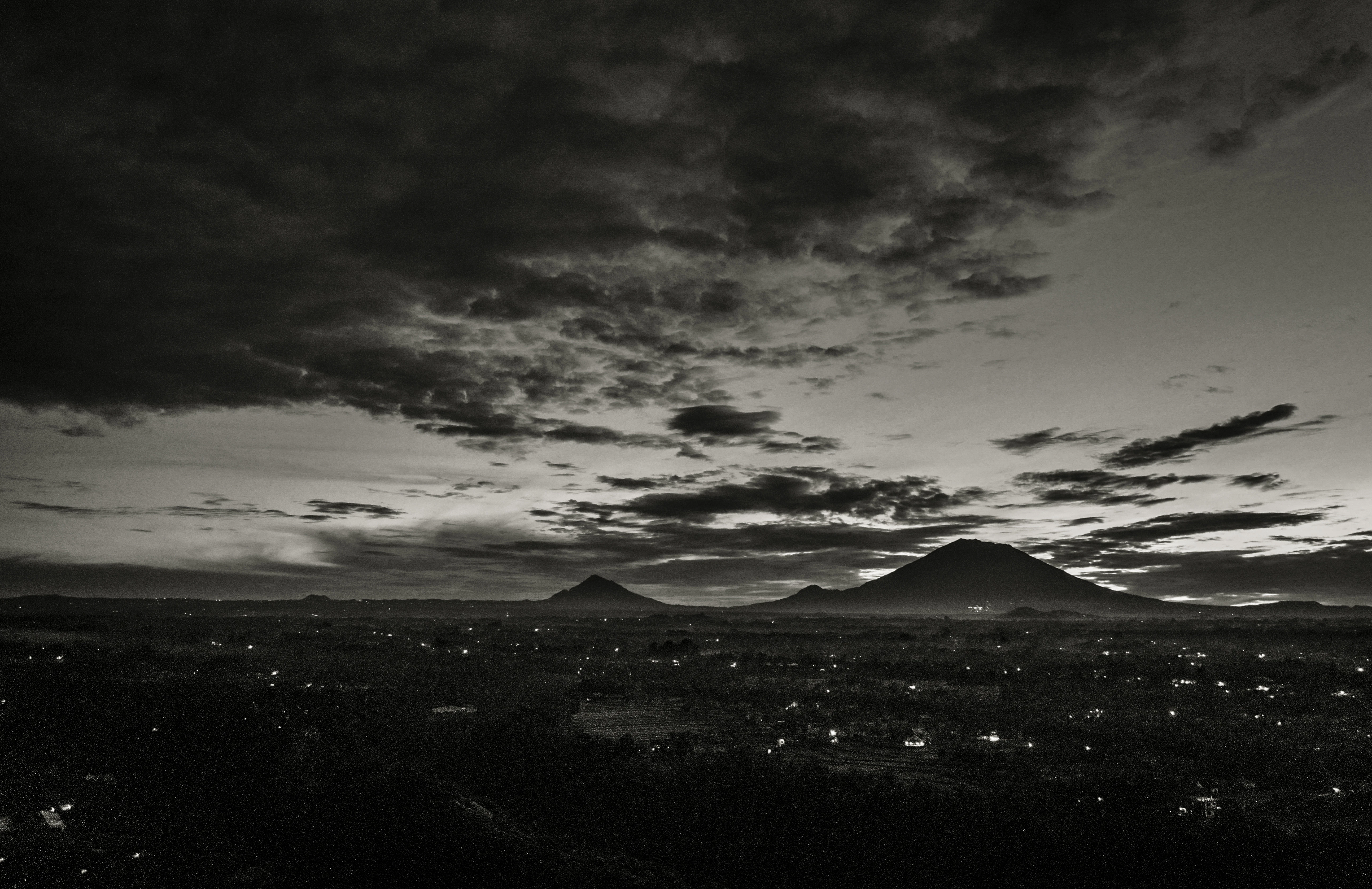silhouette of mountains under cloudy sky during daytime