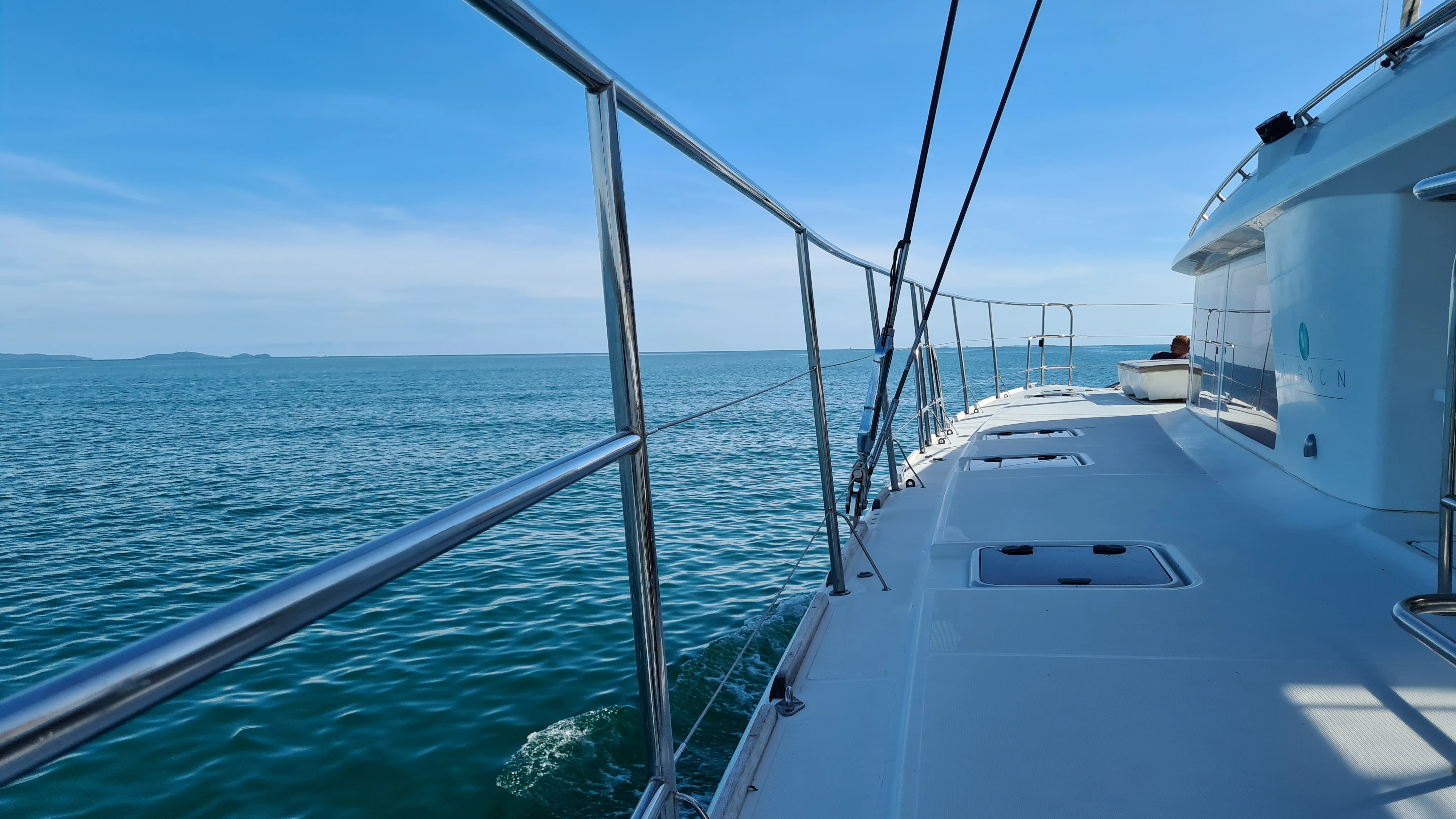 white yacht on sea under blue sky during daytime