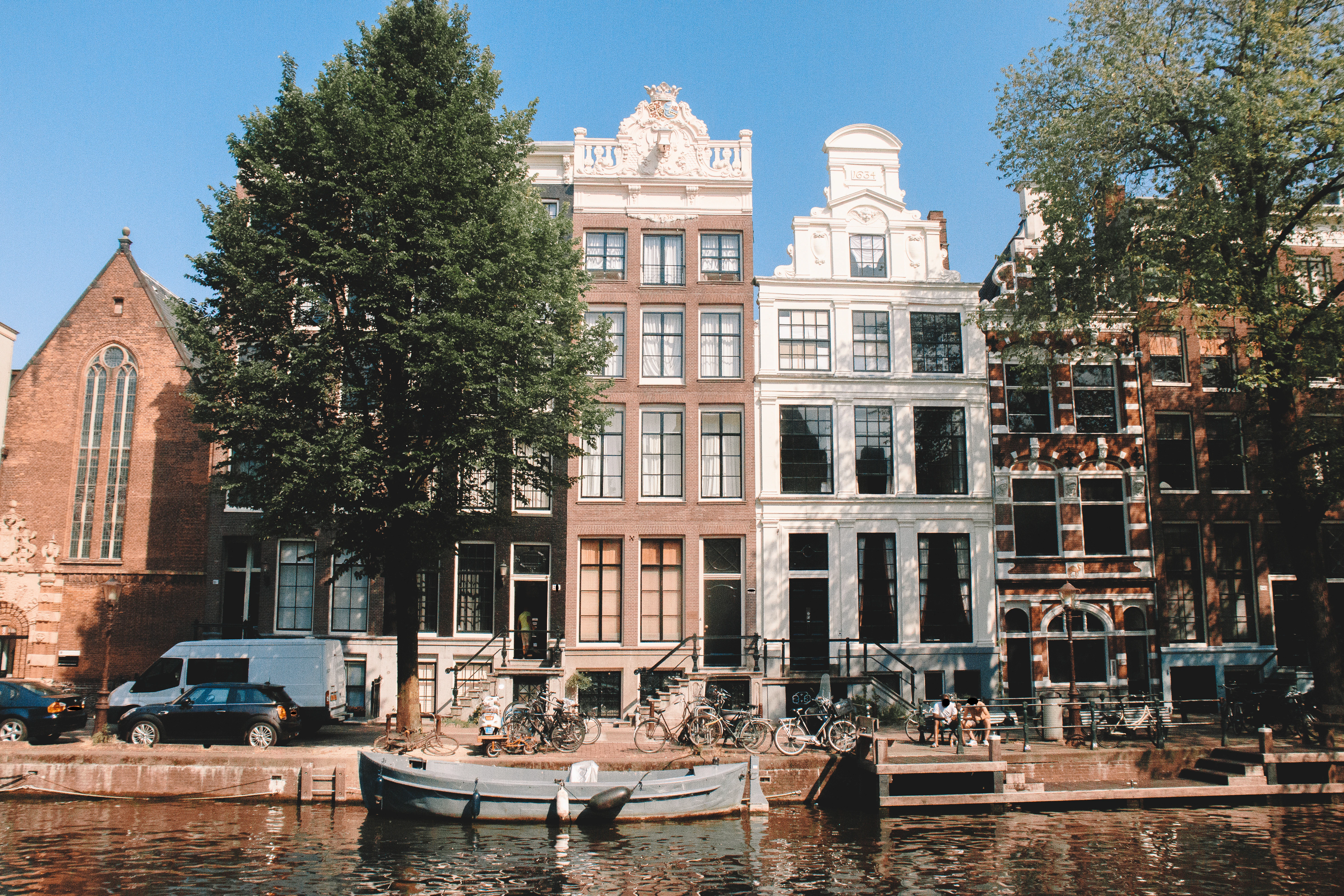 white and brown concrete building near green trees during daytime