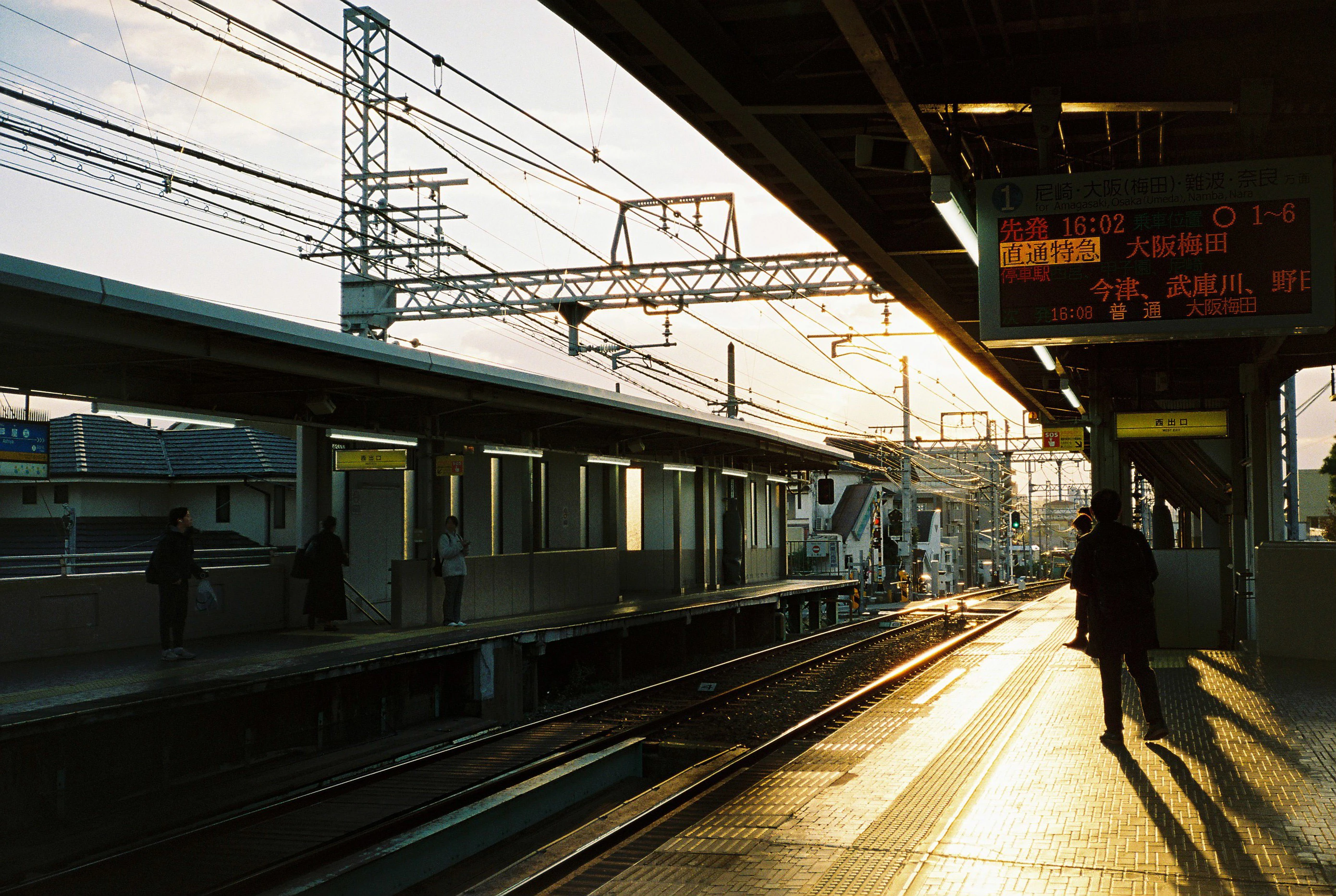 A person standing on a train platform next to a train