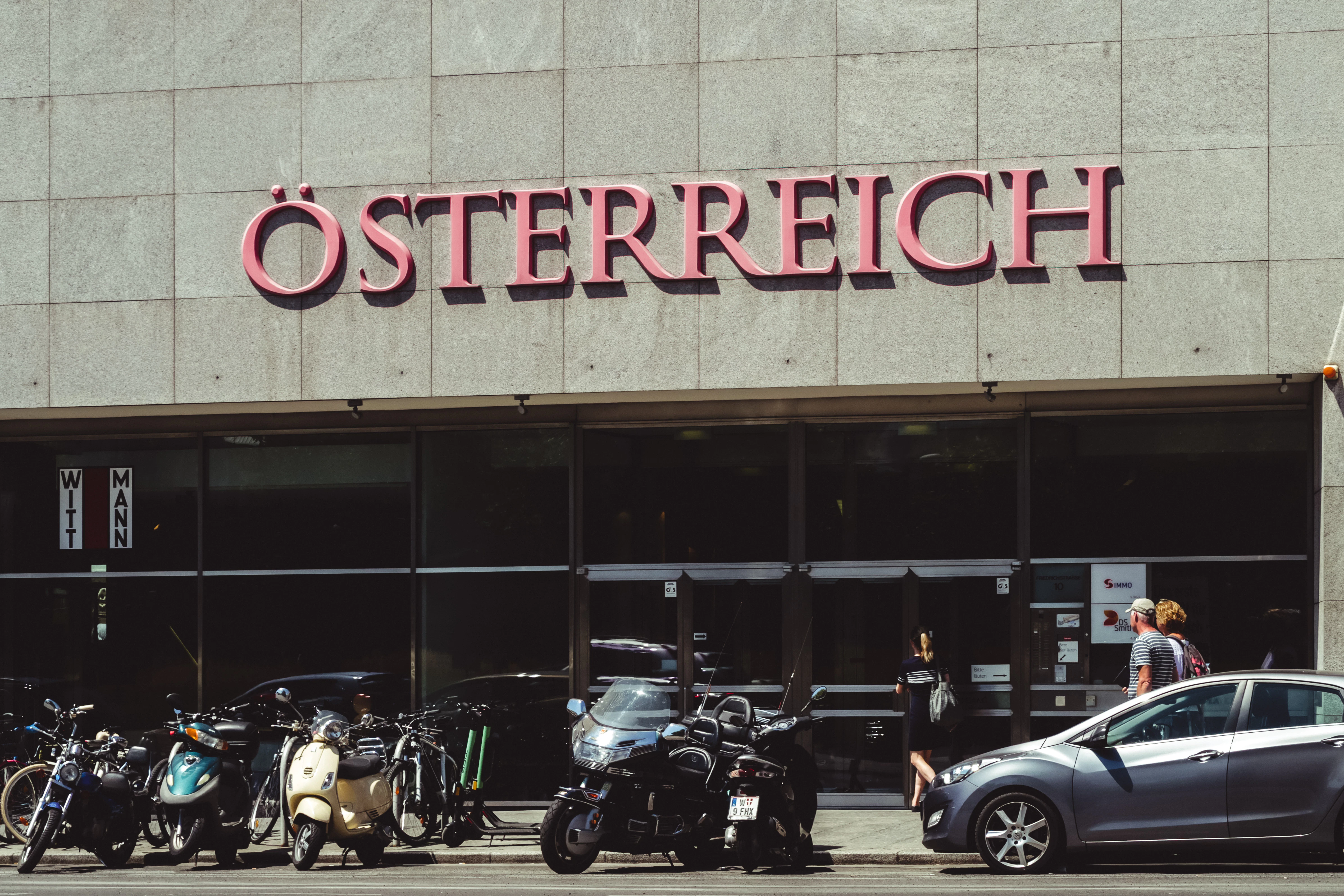 black and white motorcycle parked beside the building