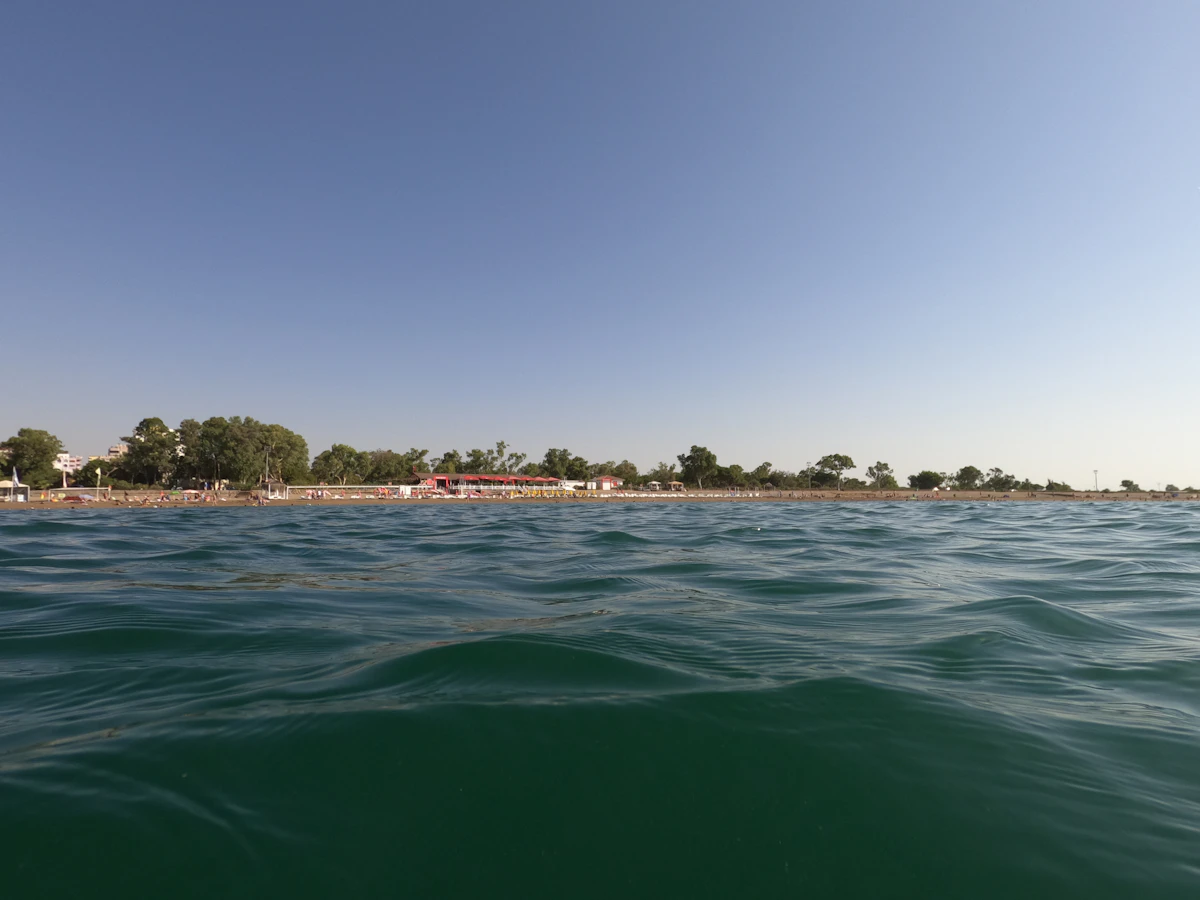 green body of water under blue sky during daytime