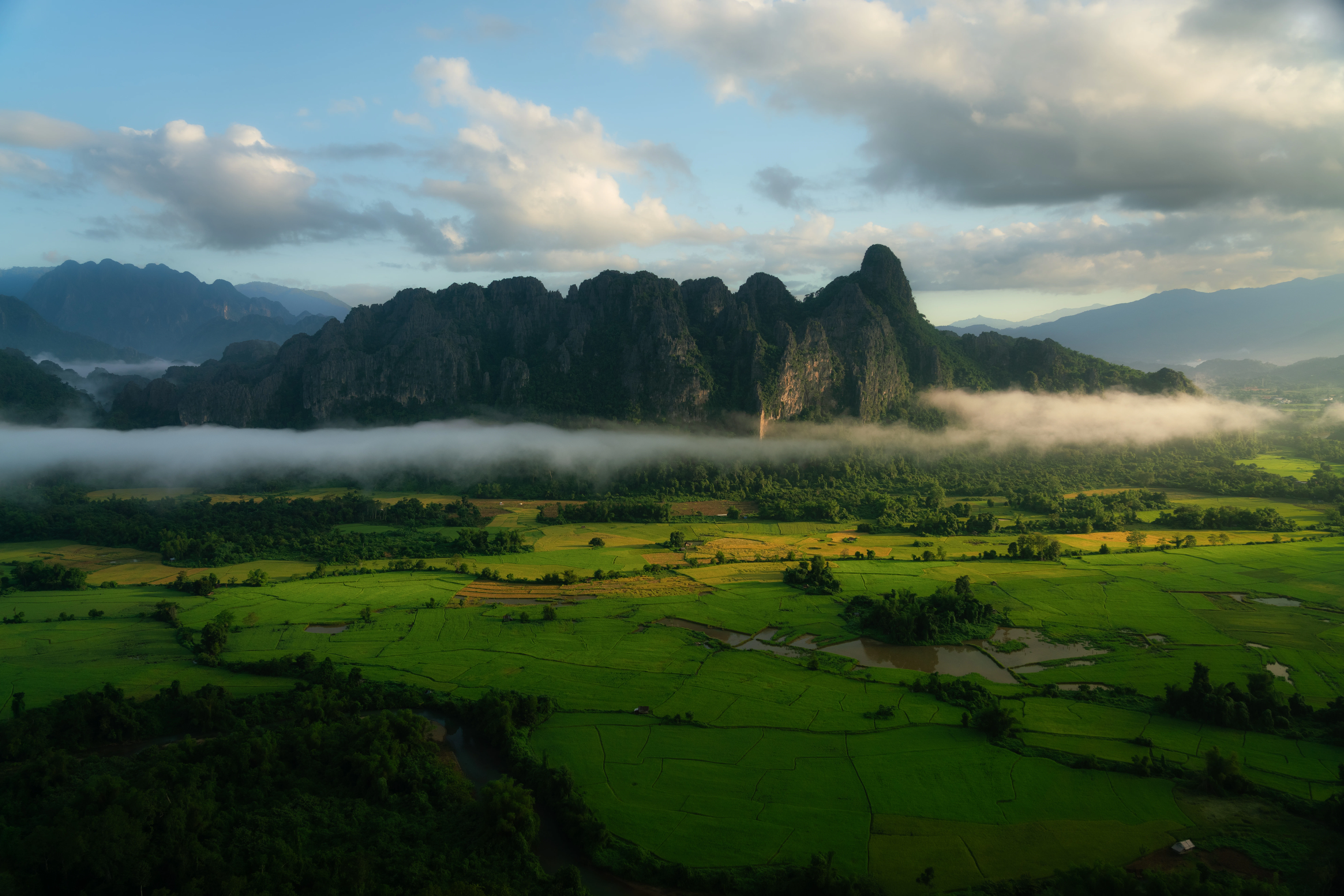 an aerial view of a mountain range in the clouds