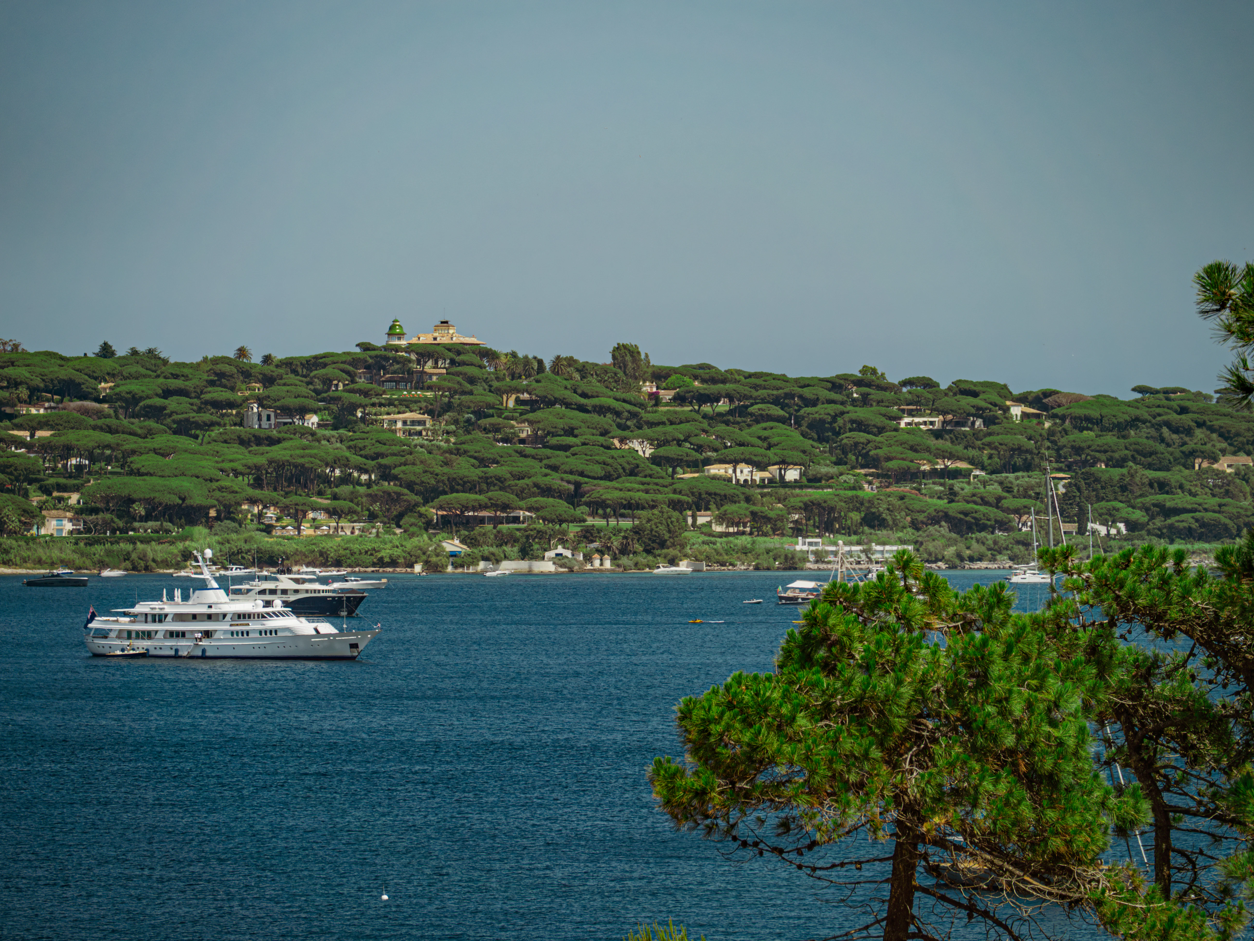 A yacht sails on beautiful, blue water.
