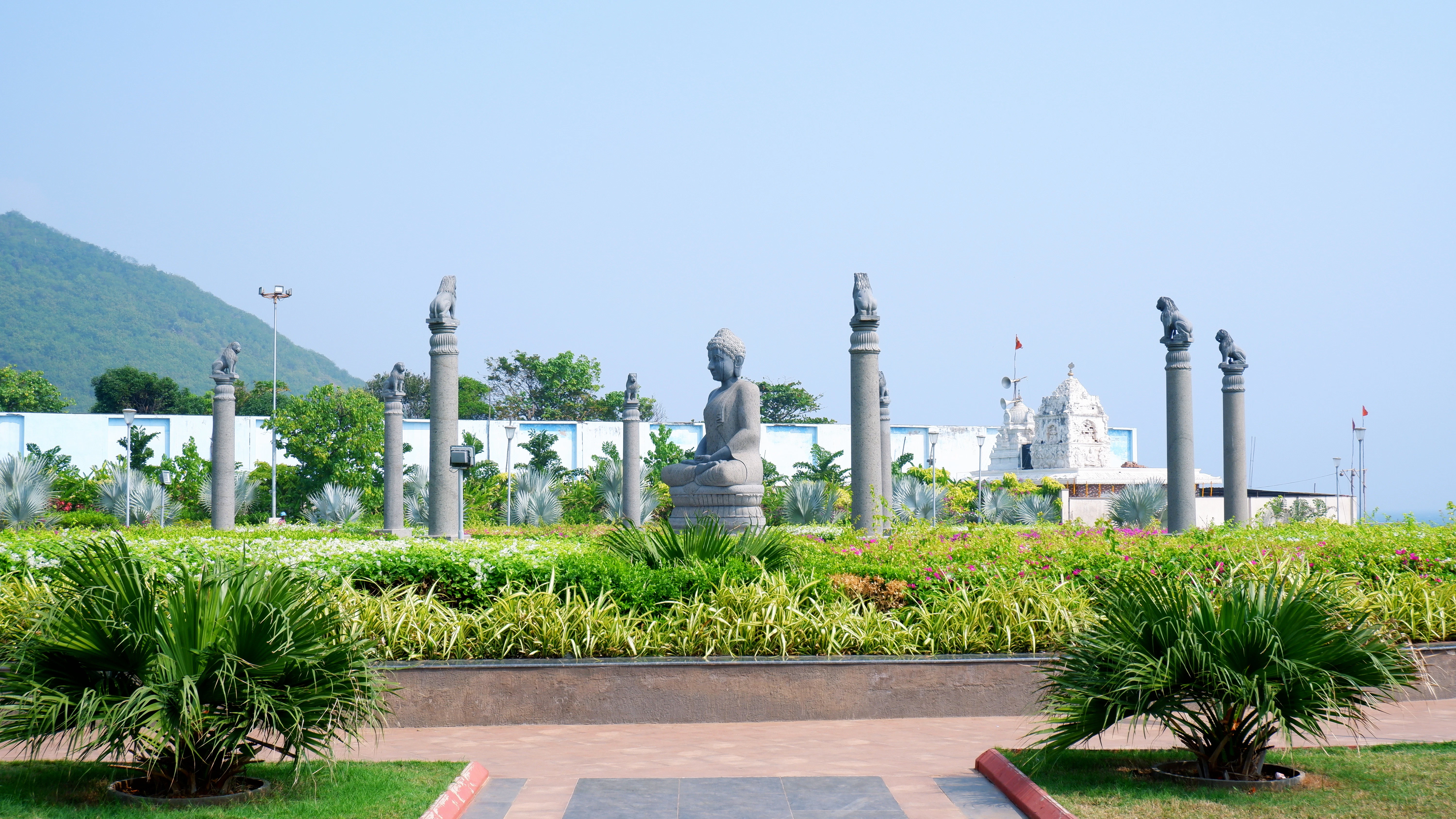A view of a park with a lot of statues in the background