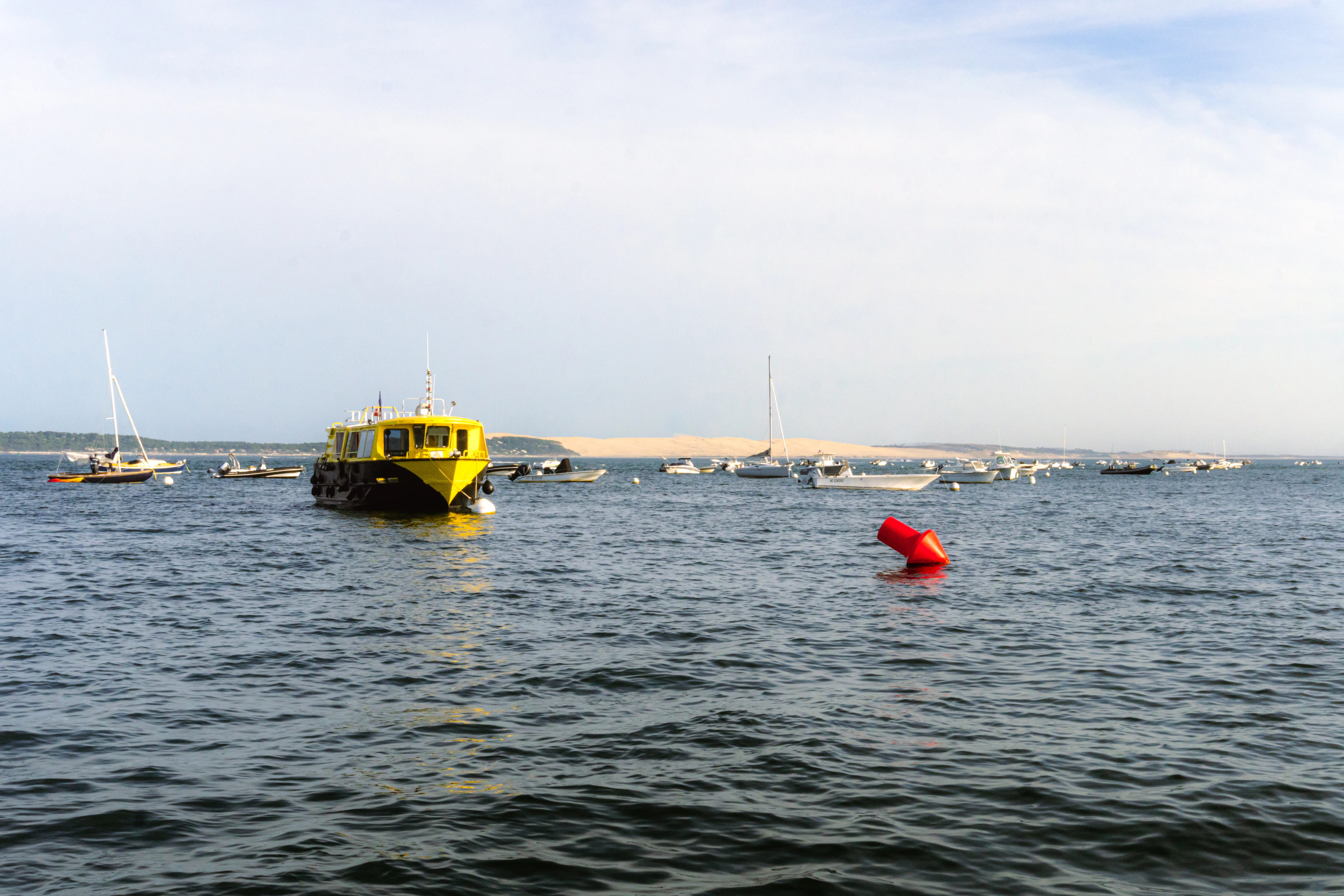 A body of water with boats in the distance
