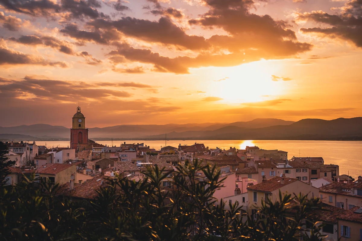 Coastal town with church tower at sunset